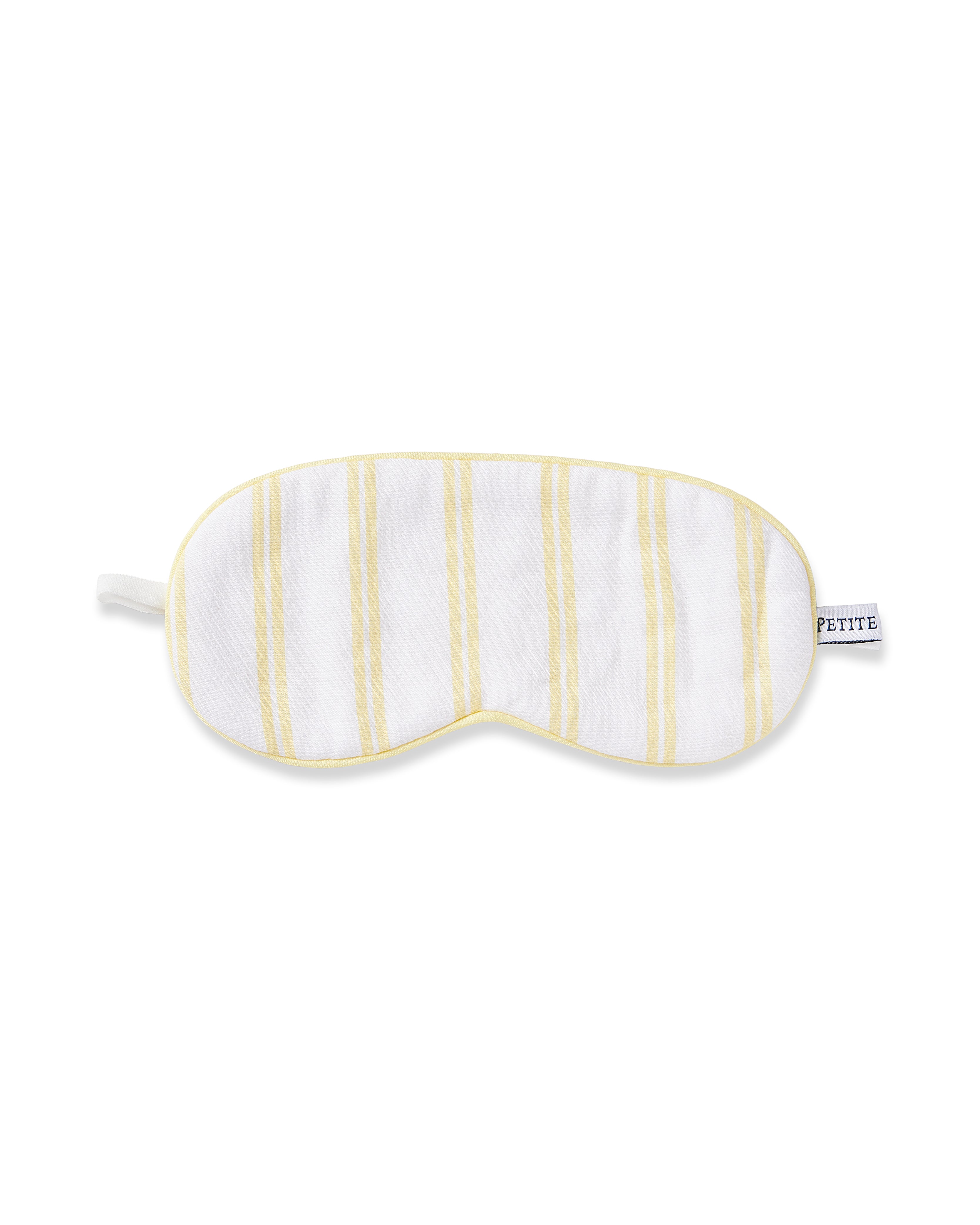 The Kids Twill Sleep Mask in Sunny Stripe by Petite Plume is a white eye mask with sunny stripes and a PETITE side label, offering full coverage for soft, comfortable sleep.