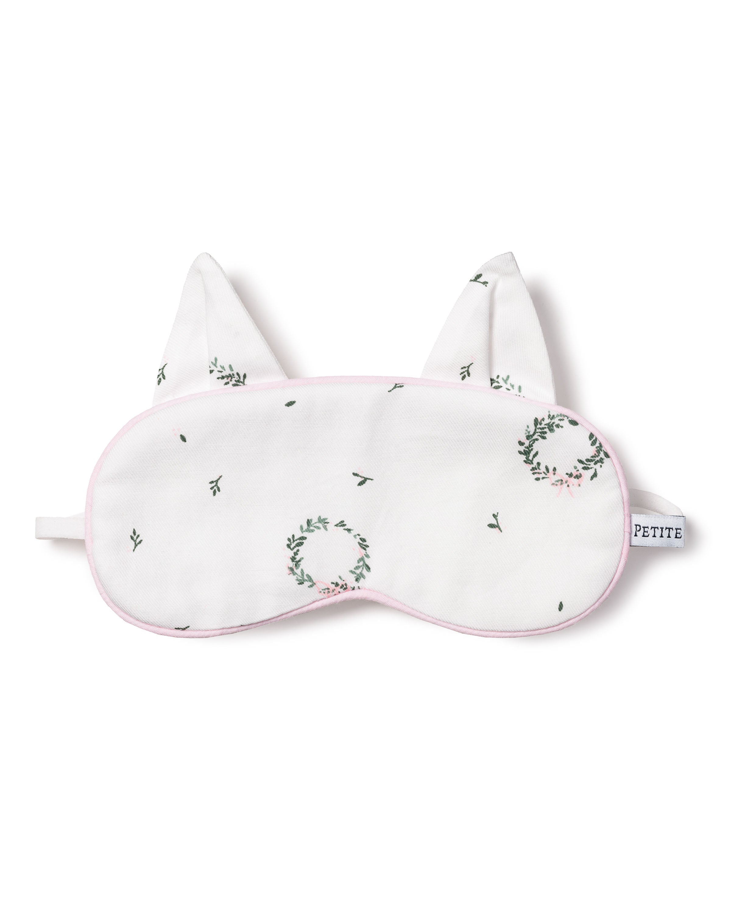 The Kids Twill Kitty Eye Mask in Somerset Wreath by Petite Plume is white with small floral wreaths and ear-like shapes. With pink trim and a PETITE tag, its an ideal gift, especially when paired with matching masks for a coordinated slumber party look.