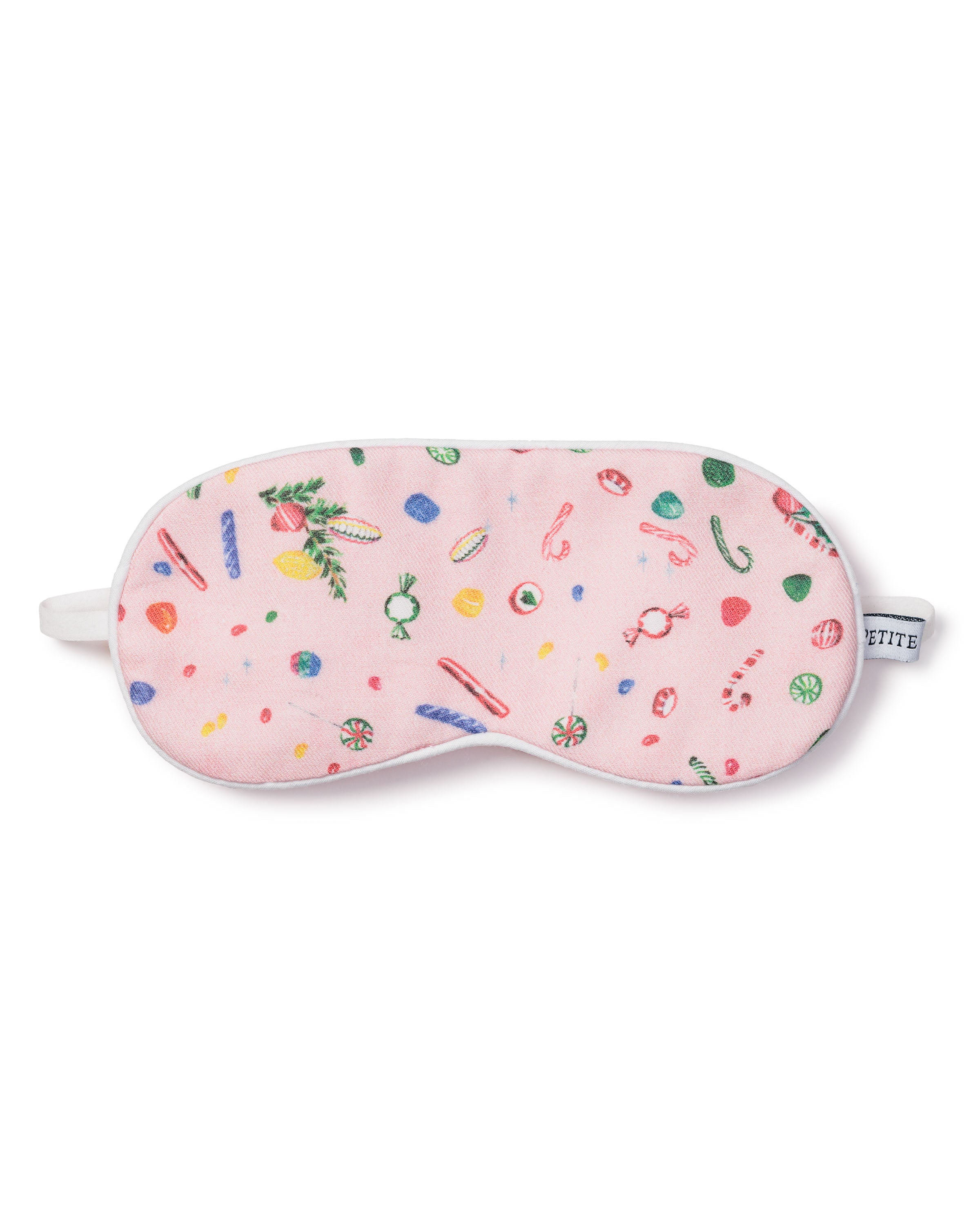 The Kids Twill Eye Mask in Vintage Sweets by Petite Plume is pink with vintage candy illustrations like lollipops and candy canes. It includes a white elastic strap, making it a charming addition to the festive season.