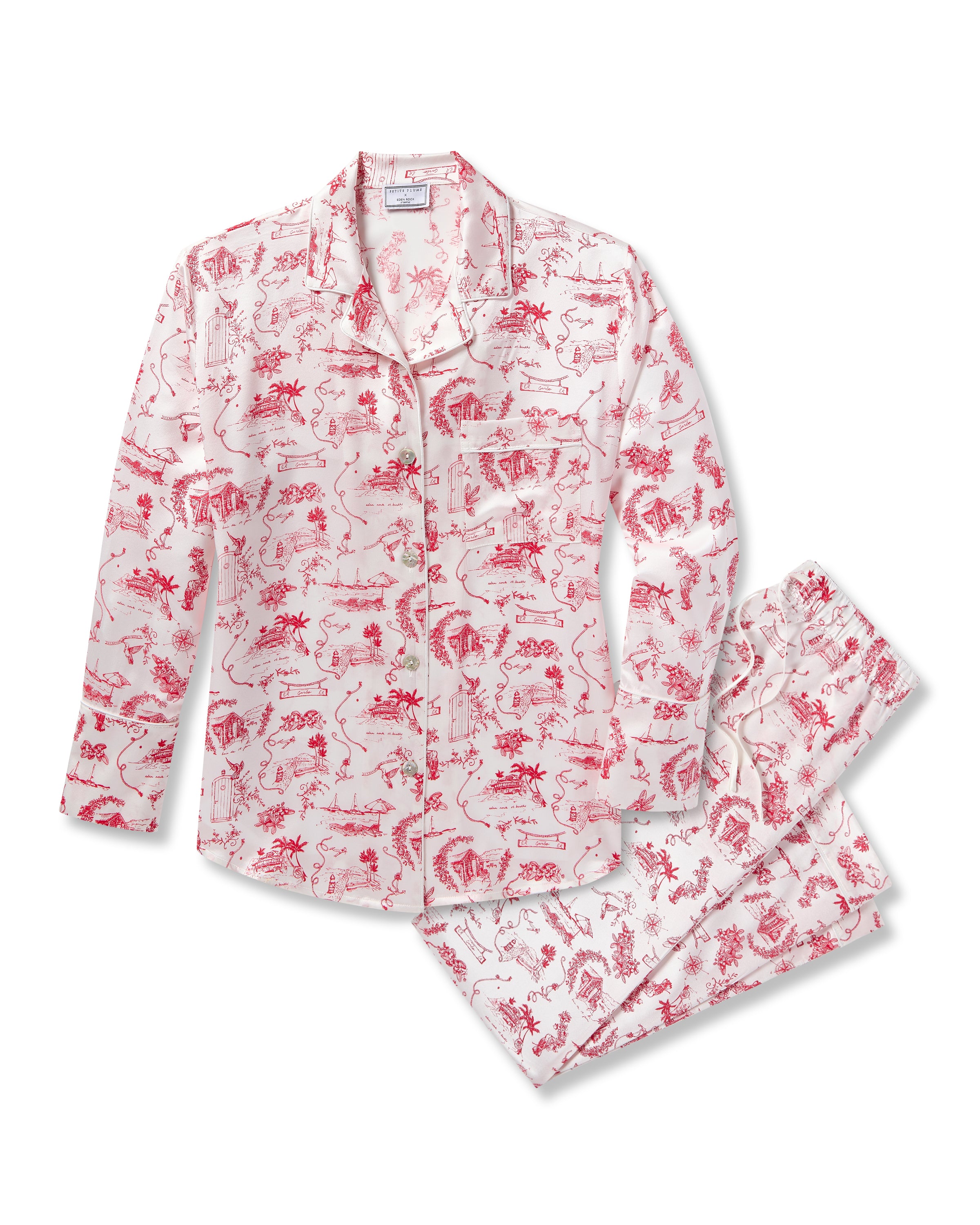 The Petite Plume x Eden Rock Reverie Women's Silk Pajama Set features a long-sleeve button-up top and pants with a white background and red toile print of scenic and animal motifs.