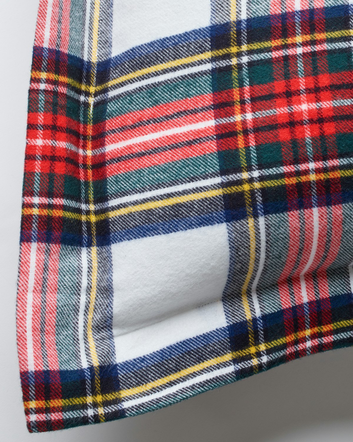 The Flannel Euro Sham in Balmoral Tartan by Petite Plume showcases a vibrant, colorful checkered pattern with red, green, blue, and yellow stripes on white. Crafted from soft brushed cotton flannel, its perfect for a cozy addition to your home decor.
