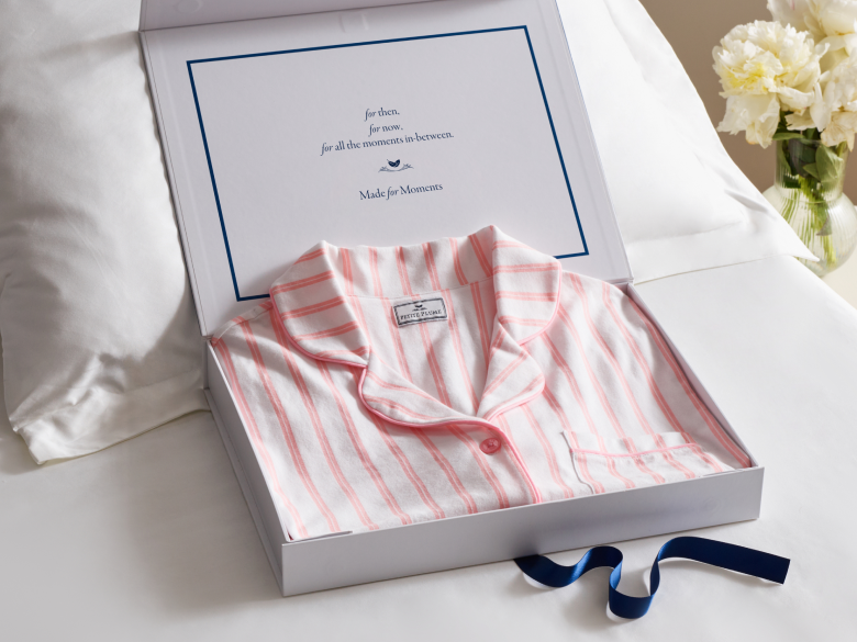 Pink stripe pajamas folded in a gift box with an inscription that reads: for then, for now, for all the moments in-between. Made for moments.