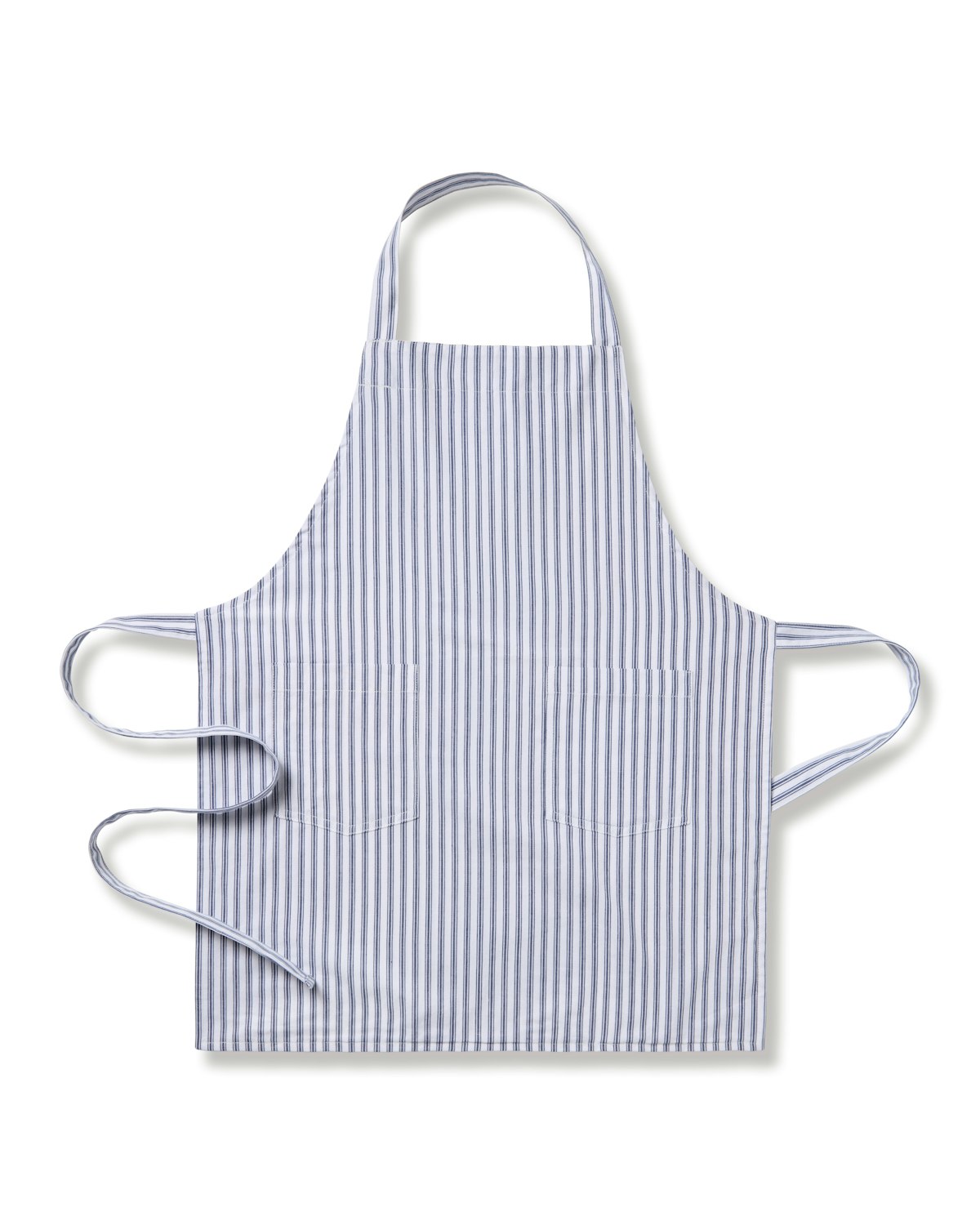 The Kids Apron in Navy French Ticking by Petite Plume, ideal for holiday baking, features light blue and white stripes with two front pockets and neck/waist ties. Available in childrens sizes, its displayed flat on a white background.
