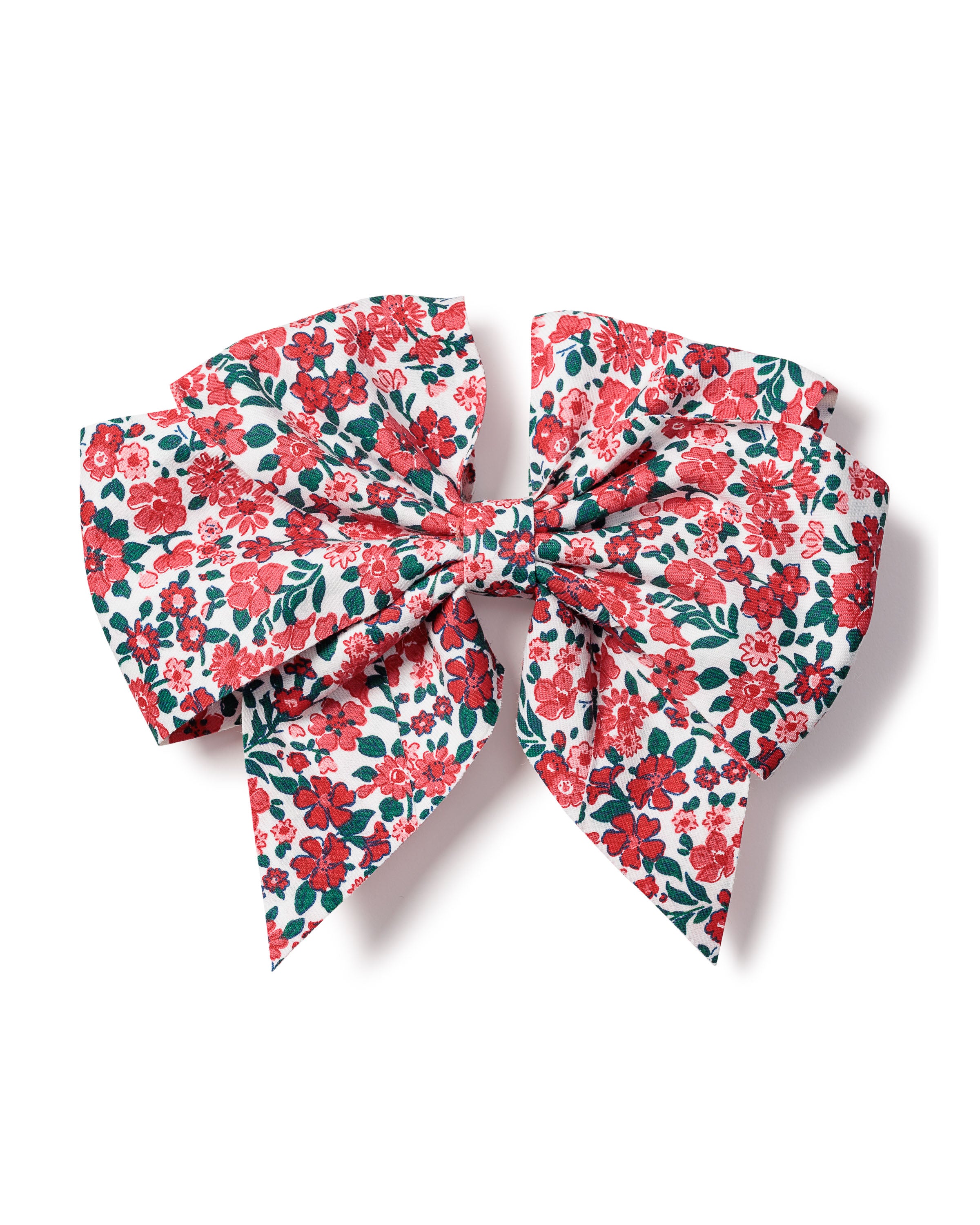 The Girls Twill Hair Bow in Fleurs des Bois by Petite Plume is a charming hair accessory featuring a vibrant floral pattern of red and pink flowers with green leaves. Its intricate design on a white background makes it a delightful addition to any girls collection.