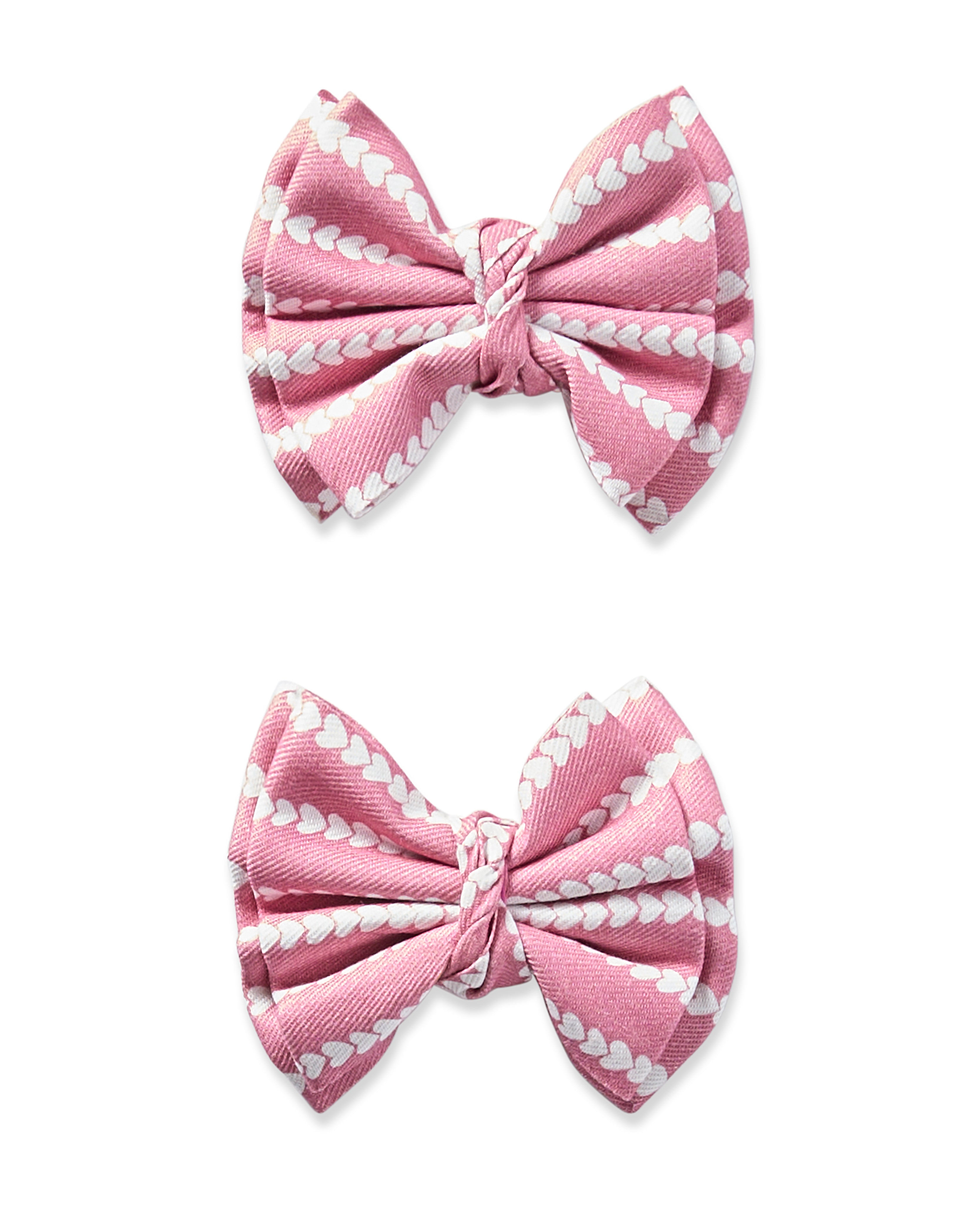 Petite Plumes Girls Twill Hair Bows in Love Lines feature two pink bows with white heart patterns, symmetrically tied and set against a white backdrop.