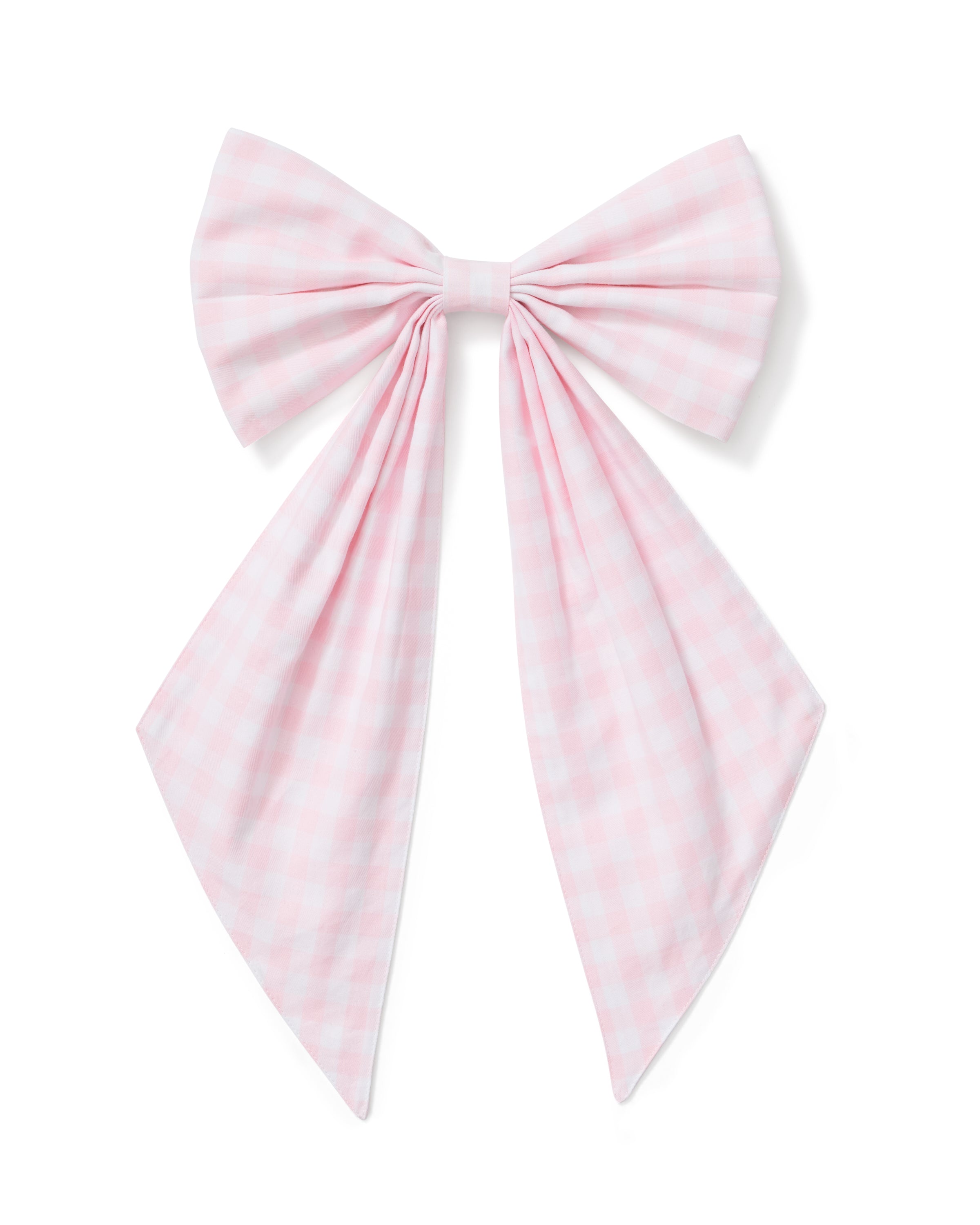 A spring wreath adorned with small white and pink flowers and greenery hangs on a beige door, finished with the Easter Basket and Wreath Bow in Pink Gingham at the bottom.