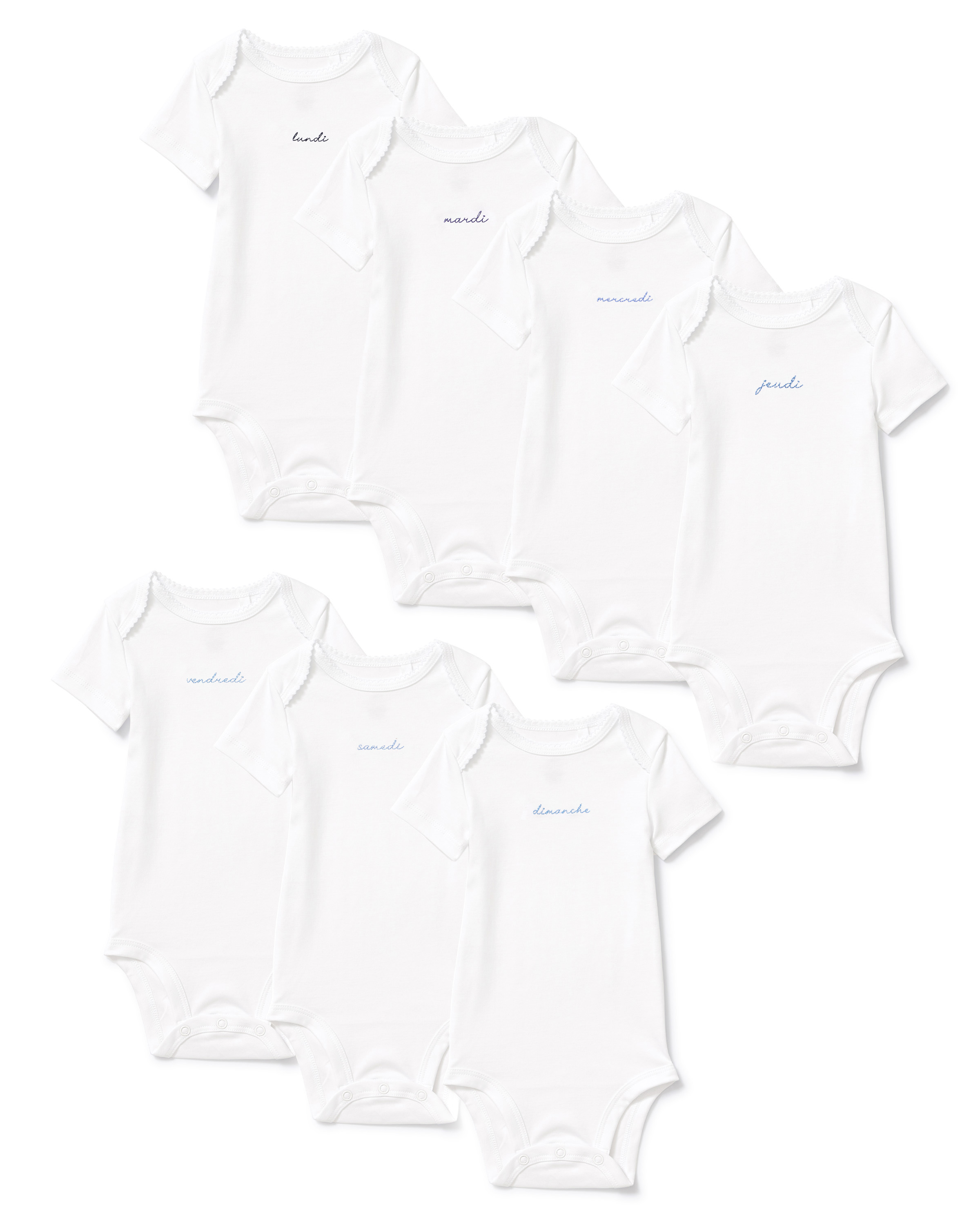 Seven white Baby’s Pima Short Sleeve Onesies from the French Lessons Blue set are arranged in two rows, each featuring a day of the week written in cursive on the chest in light blue or gray text.