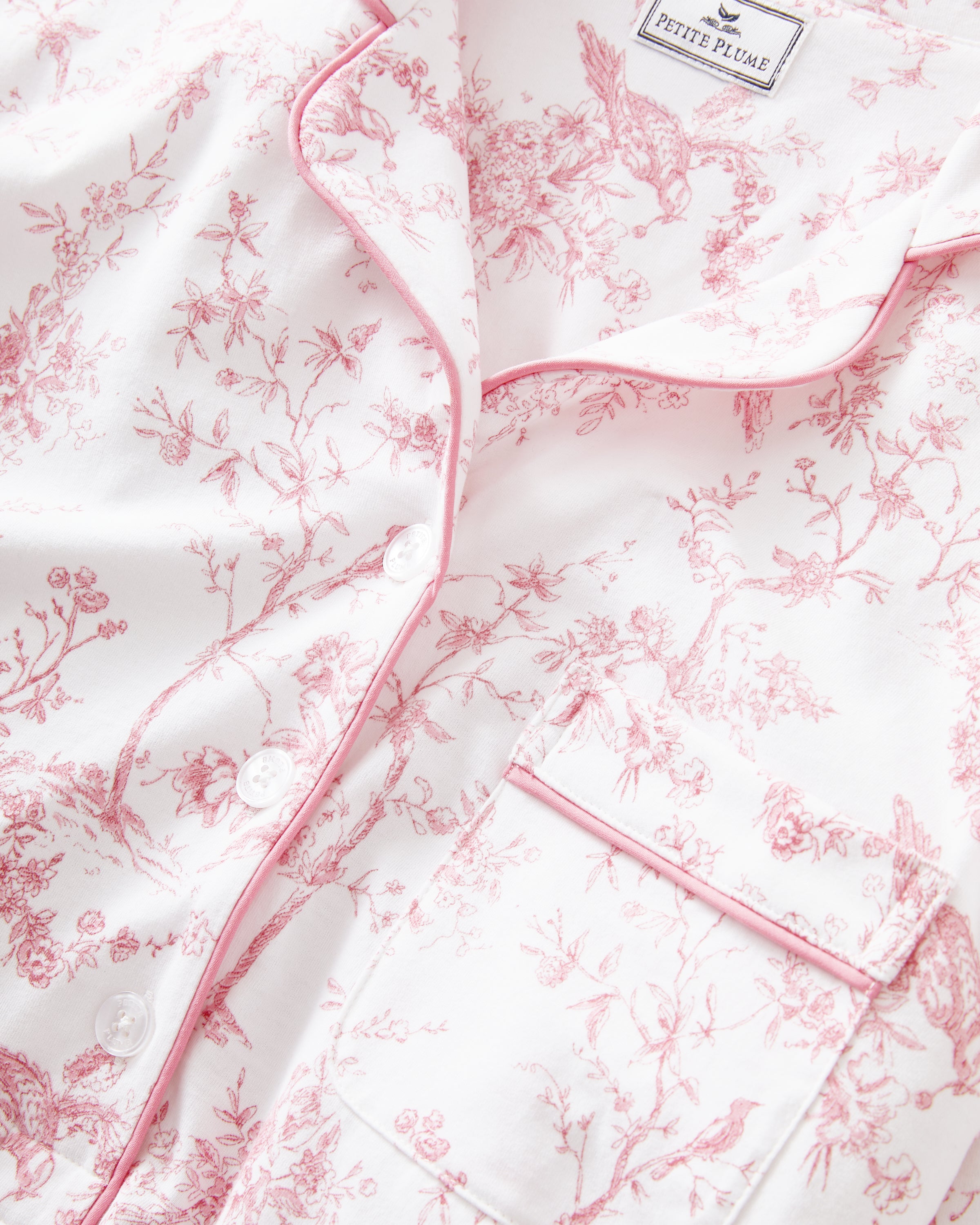 The Women's Pima Maternity Nightshirt in Pink Timeless Toile features long sleeves, a button-up front, a chest pocket, and a relaxed fit with a pink floral toile pattern on white.