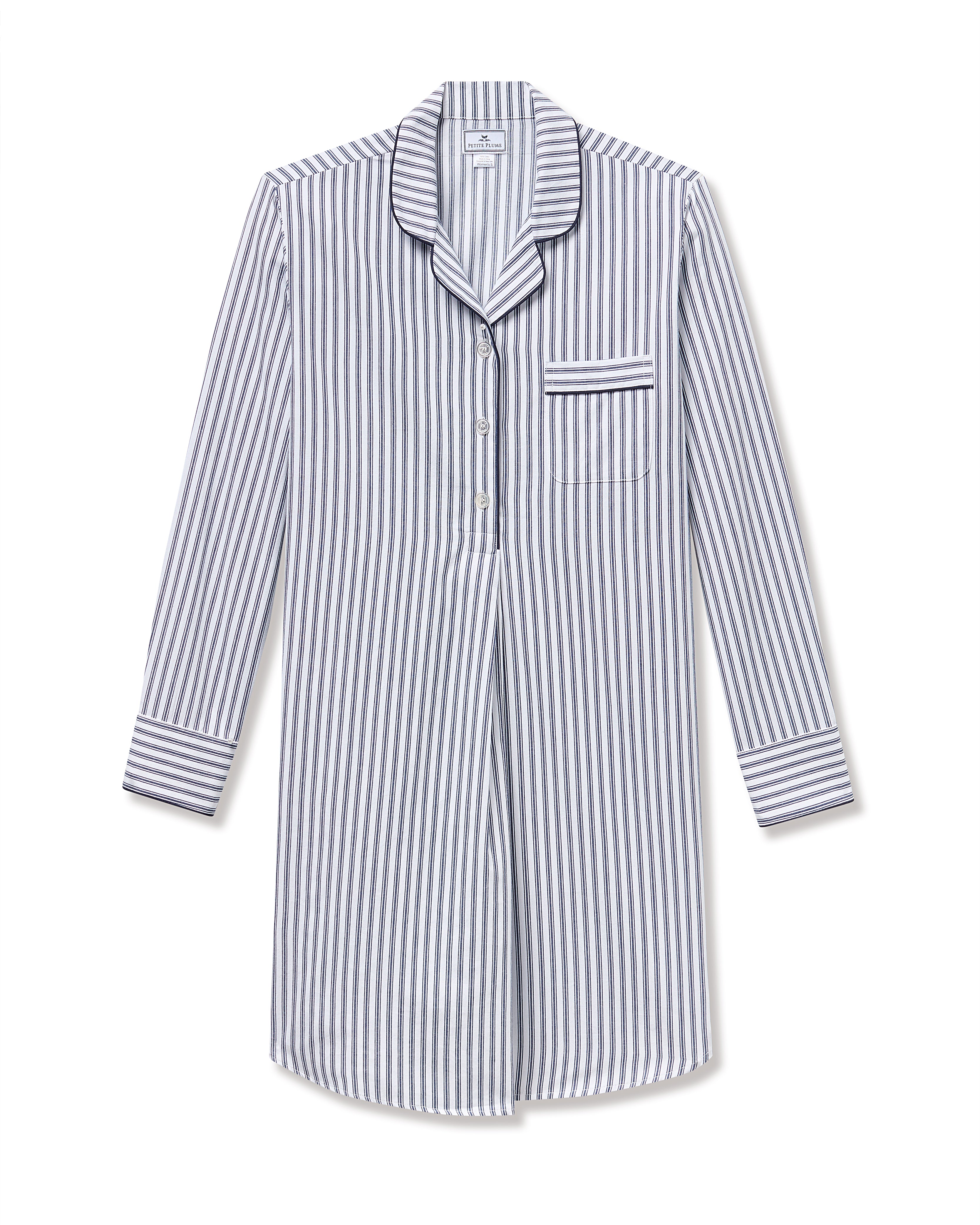 The Womens Twill Maternity Nightshirt in Navy French Ticking by Petite Plume is a luxurious, long-sleeved cotton nightshirt with vertical stripes. It features a button-up front, dark piping on the collar, and a pocket on the left chest, showcasing yarn-dyed navy and white stripes for timeless elegance.