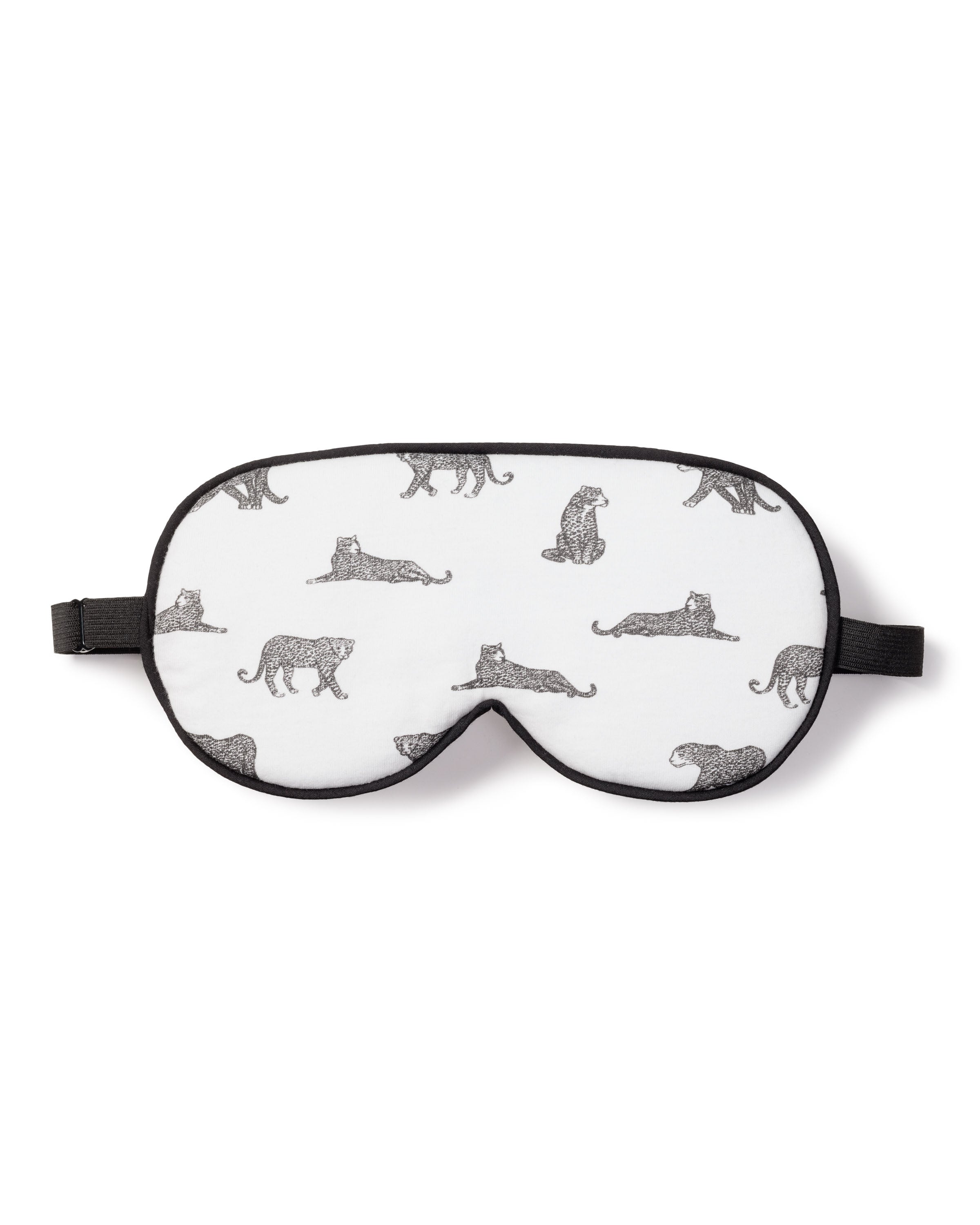 The Womens Pima Sleep Mask in Panthère de Paris by Petite Plume is a luxury white mask trimmed in black, featuring seated and walking leopards in monochrome. Its adjustable black strap makes it an elegant, stylish accessory and the perfect monogrammed gift.