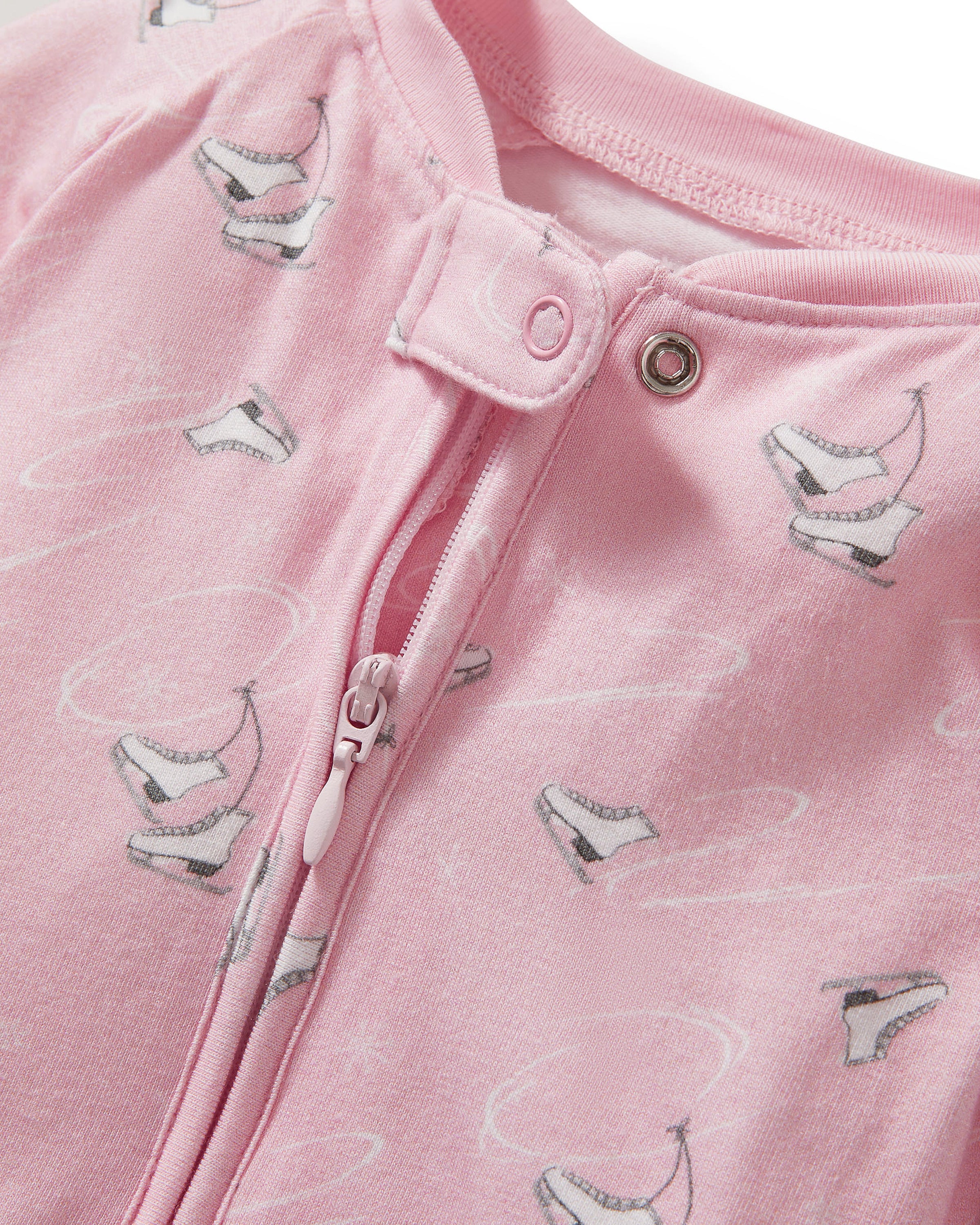 The Baby's Pima Peekaboo Romper in Winter Skates is a pink long-sleeve, long-leg romper with a subtle white bird print, diagonal neck-to-leg zipper, and ribbed cuffs at wrists and ankles.
