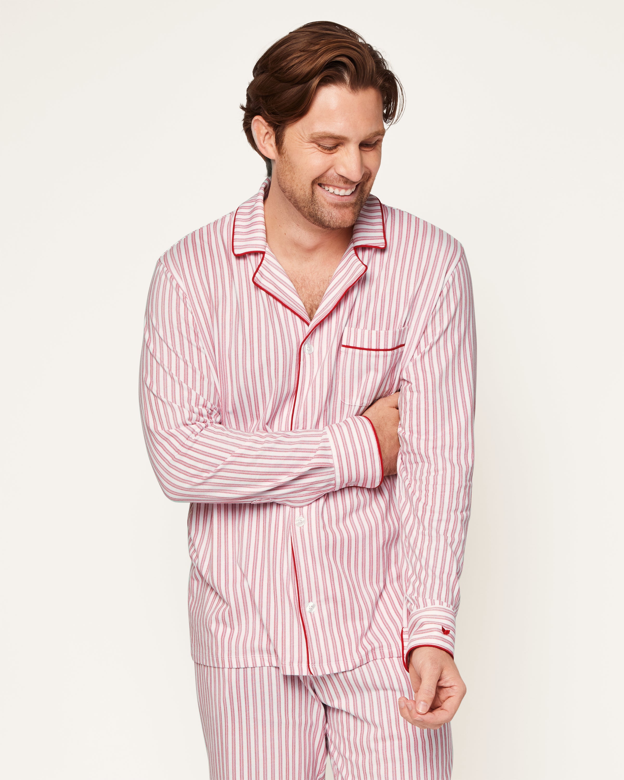 This close-up features the Mens Pima Pajama Top by Petite Plume in Antique Red Ticking. The luxurious yarn-dyed Peruvian Pima cotton showcases vertical red and white stripes with a visible button and pocket outlined in red piping, ensuring softness and comfort for restful nights.