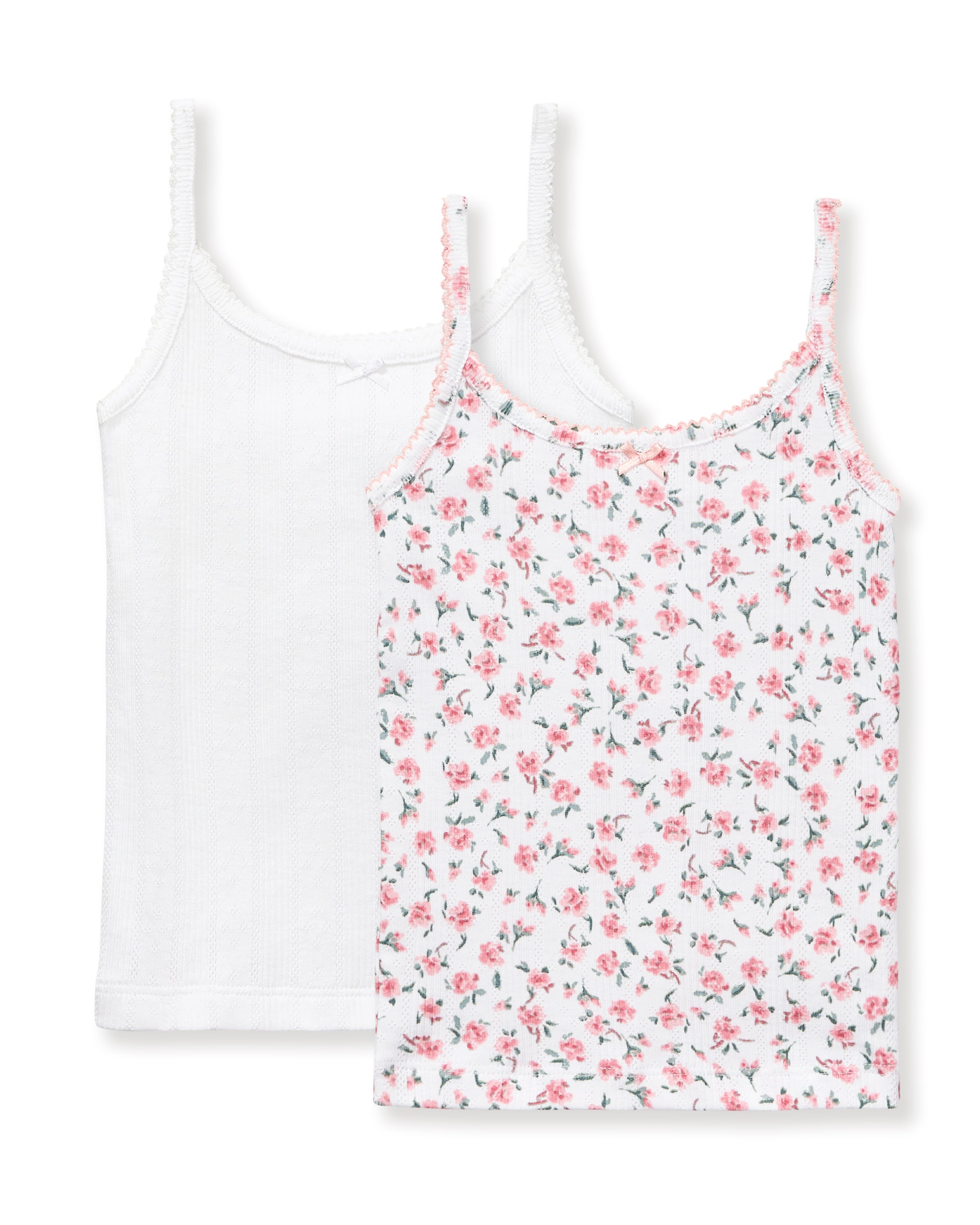 The Kid's Pointelle Cami Set of 2 in White & Pink Floral includes two sleeveless camisoles: one plain white with a bow and one white with a pink and green floral pattern. Both feature thin straps and lace trim.