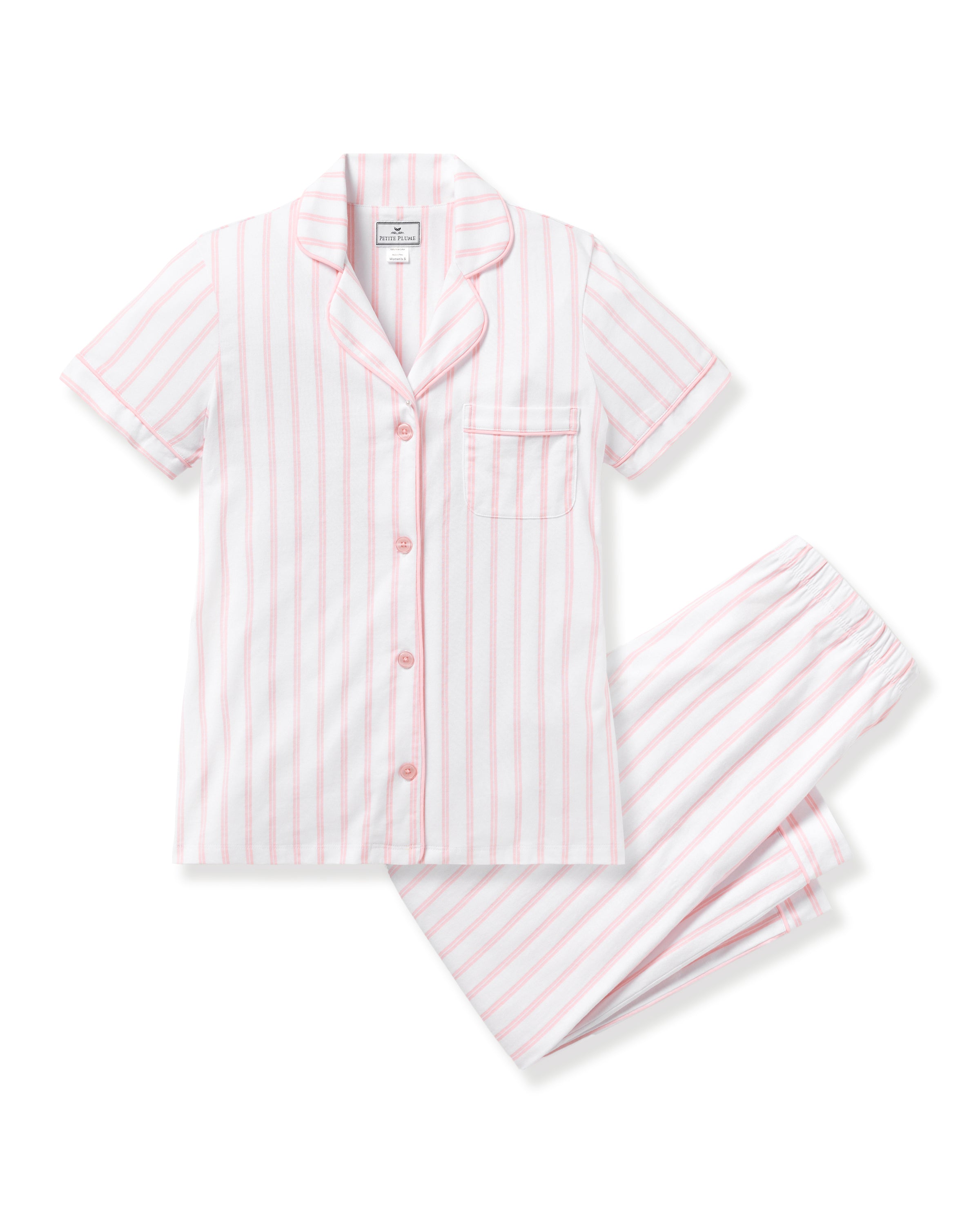 The Womens Pima Crop Set by Petite Plume, in pink and white stripe, features short-sleeved pajamas made from Peruvian Pima cotton. It includes a button-up shirt with a chest pocket and matching elastic waistband pants, displayed on a white background.