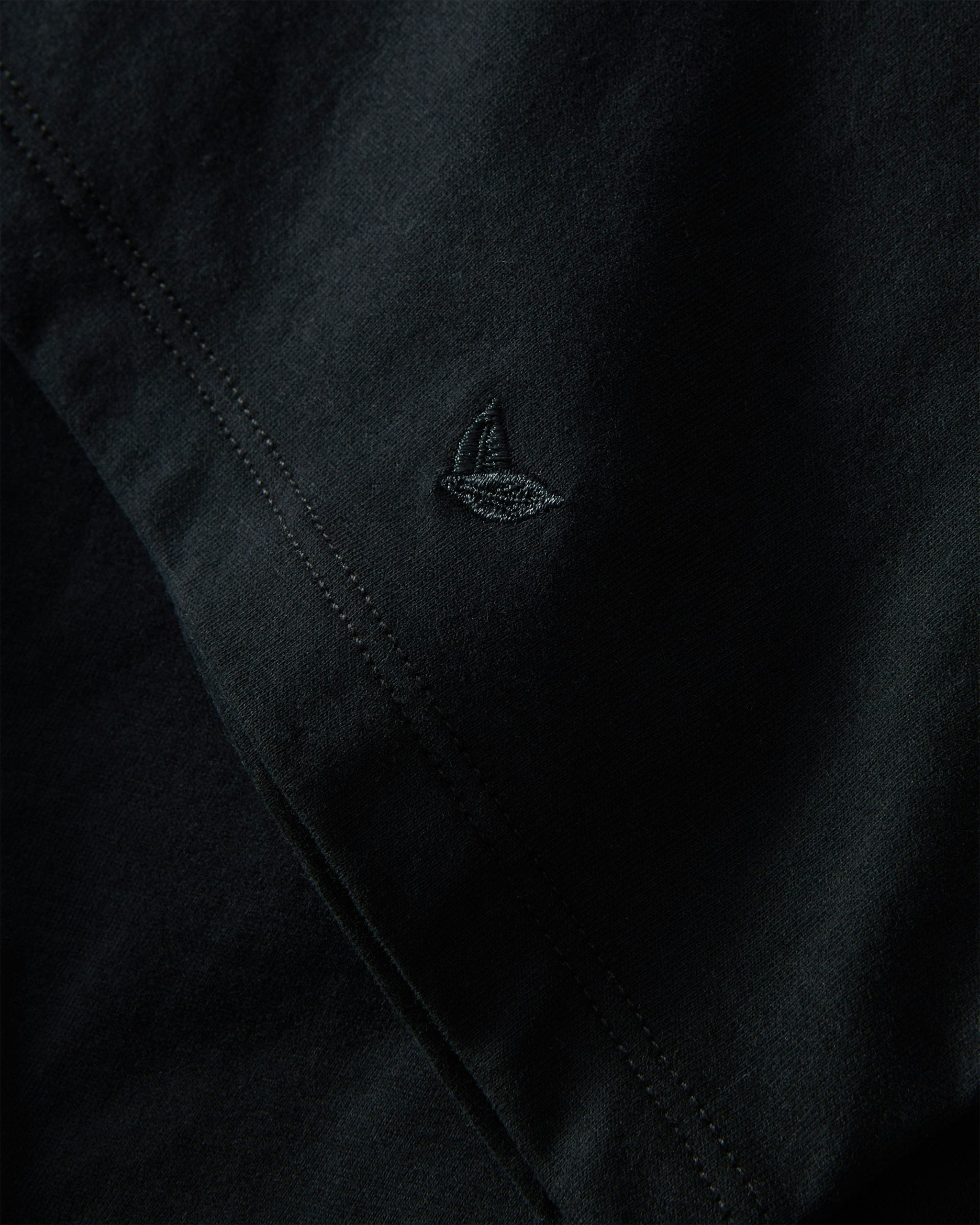 A black crew neck t-shirt made from pima cotton, displayed against a white background.