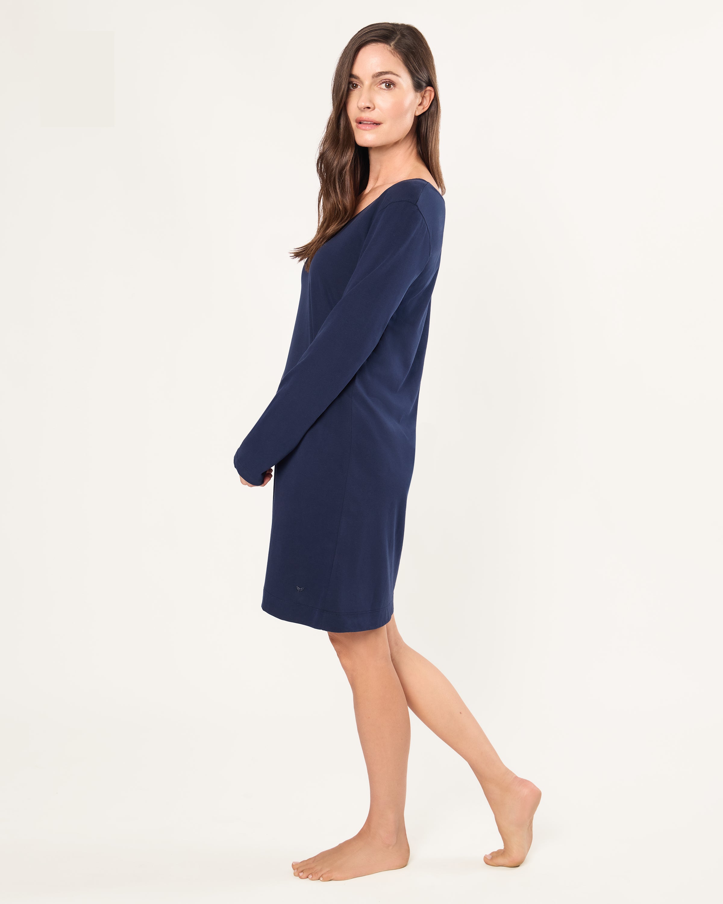Woman wearing a navy blue dress on a white background