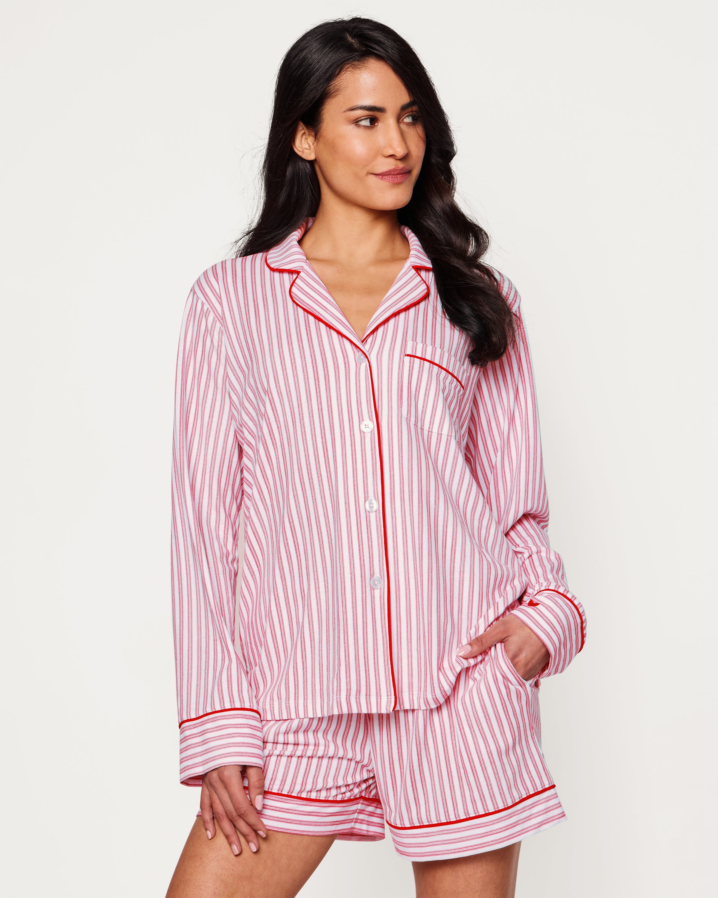 Close-up of Petite Plumes Womens Pima Long Sleeve Short Set in Antique Red Ticking. Crafted from luxurious Pima cotton with vertical red and white stripes, it features tailored piping on the collar and pocket, and a single white button exemplifying sleepwear elegance.