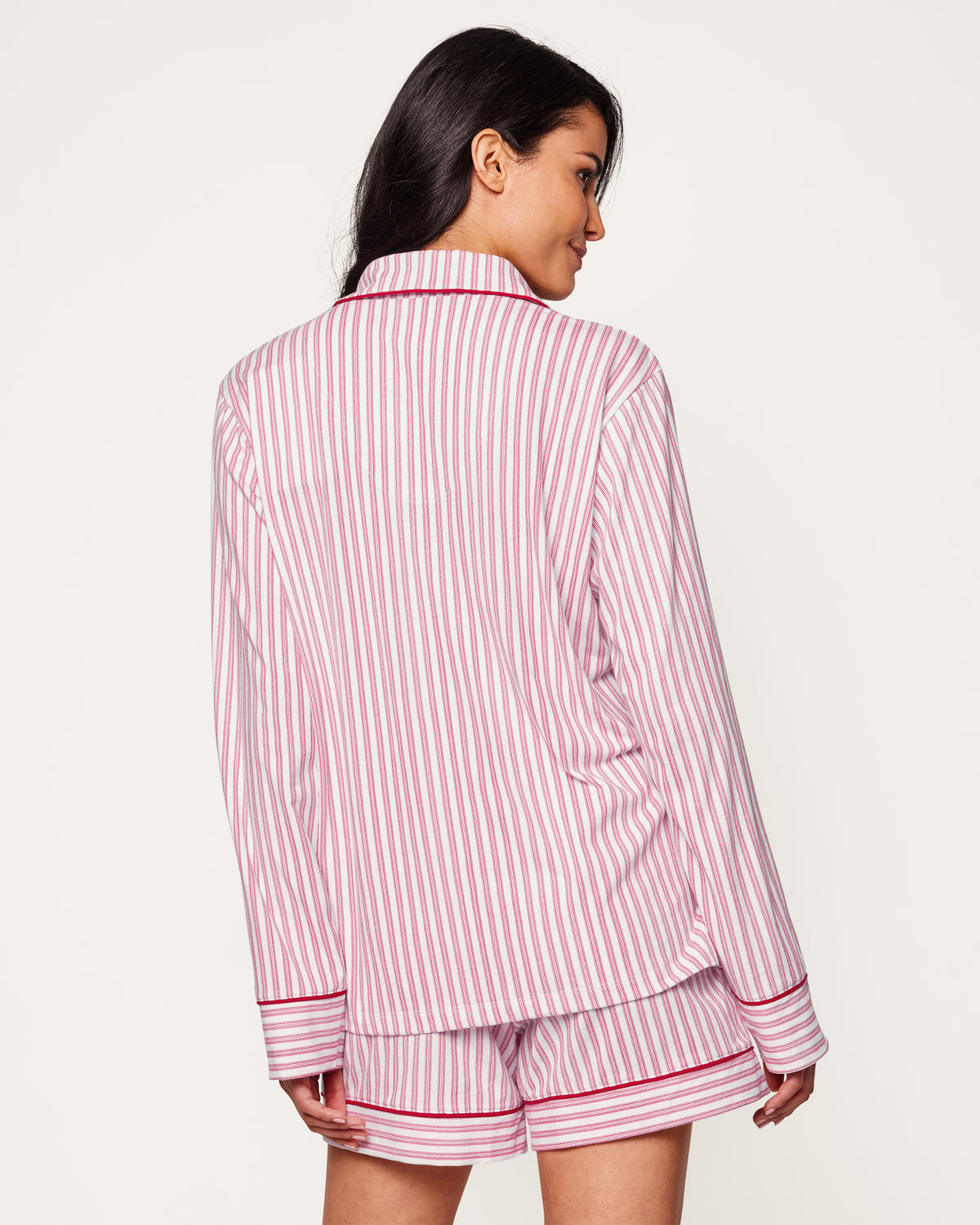 Close-up of Petite Plumes Womens Pima Long Sleeve Short Set in Antique Red Ticking. Crafted from luxurious Pima cotton with vertical red and white stripes, it features tailored piping on the collar and pocket, and a single white button exemplifying sleepwear elegance.