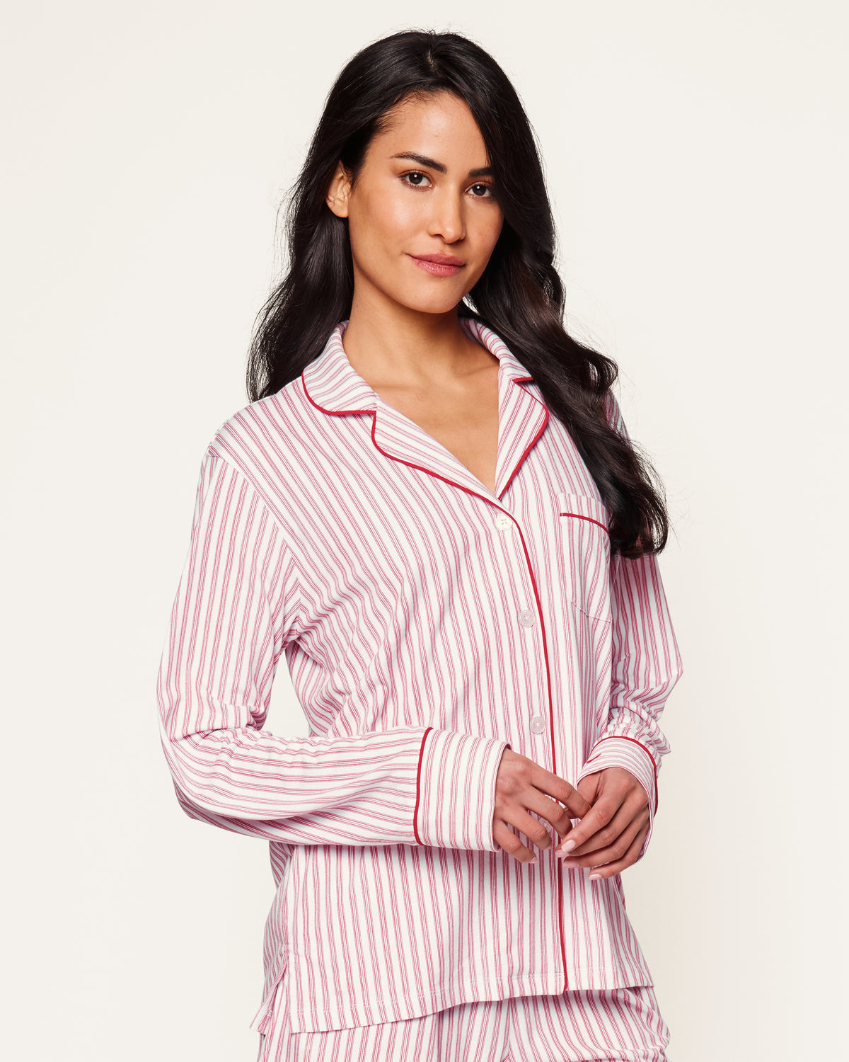 Close-up of Petite Plumes Womens Pima Long Sleeve Short Set in Antique Red Ticking. Crafted from luxurious Pima cotton with vertical red and white stripes, it features tailored piping on the collar and pocket, and a single white button exemplifying sleepwear elegance.