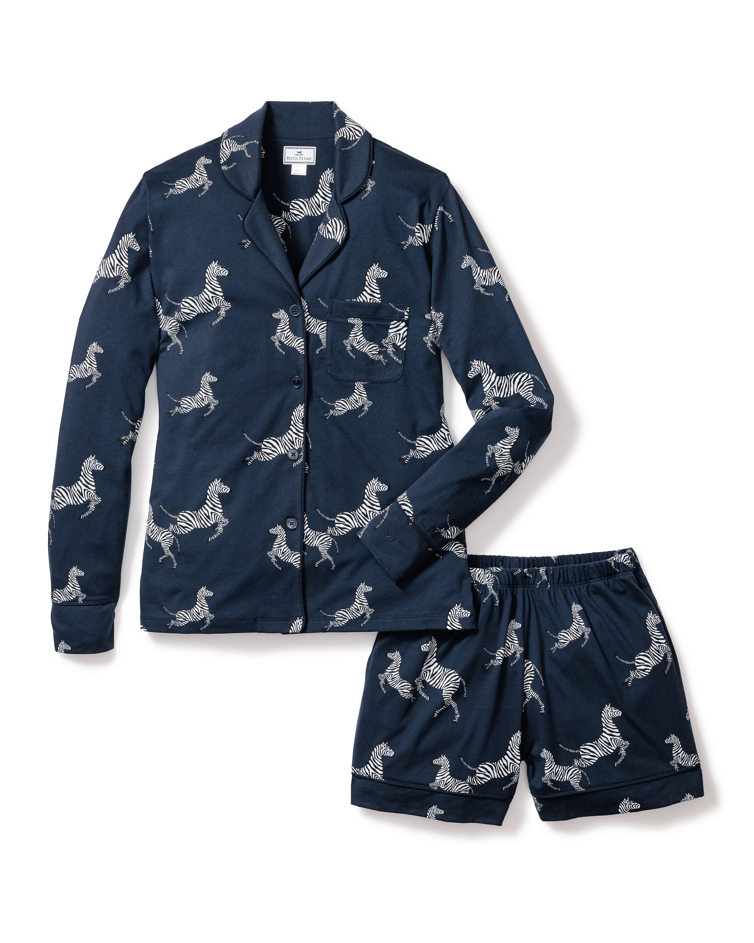Indulge in luxury with Petite Plumes Womens Pima Long Sleeve Short Set in Zèbre de Nuit, crafted from exquisite Peruvian Pima cotton. This chic dark blue set features a zebra print, including a long-sleeve button-up shirt and comfy shorts, perfect for stylish nights in.