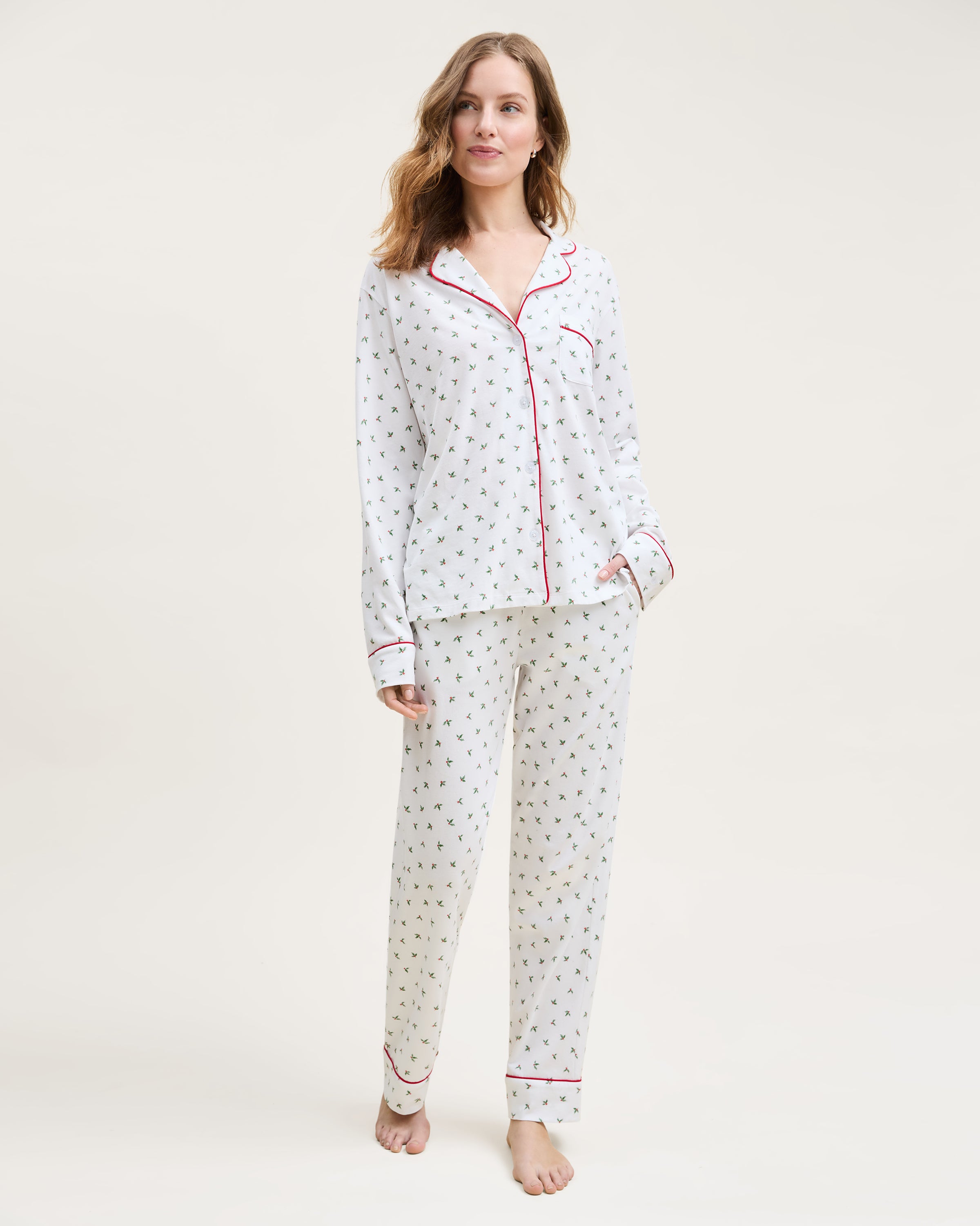 Women's Pima Pajama Set in Mistletoe Moments features small green palm tree prints, red piping, a chest pocket, and matching pants, all displayed flat on a white background.