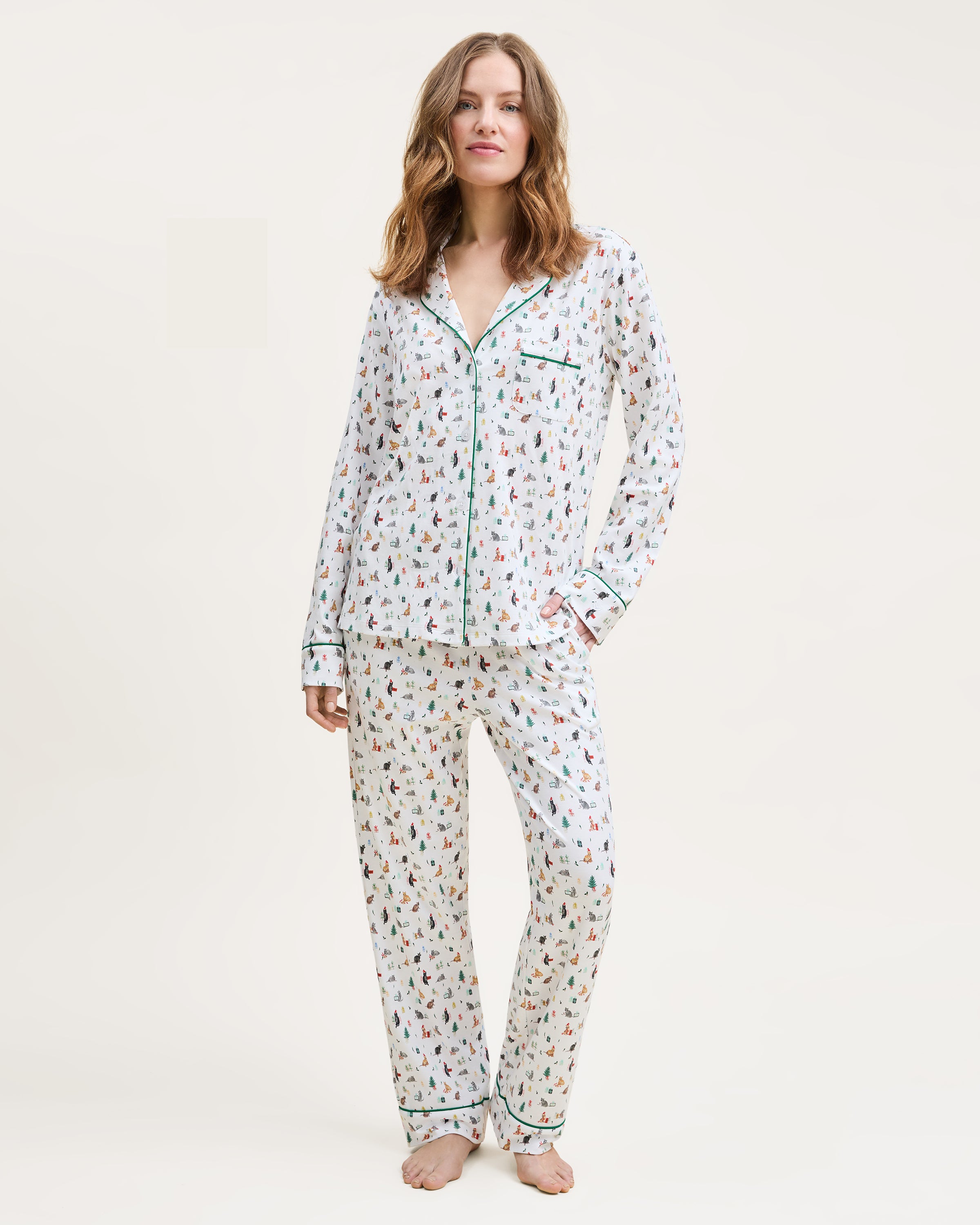 Woman wearing a floral pajama set on a white background