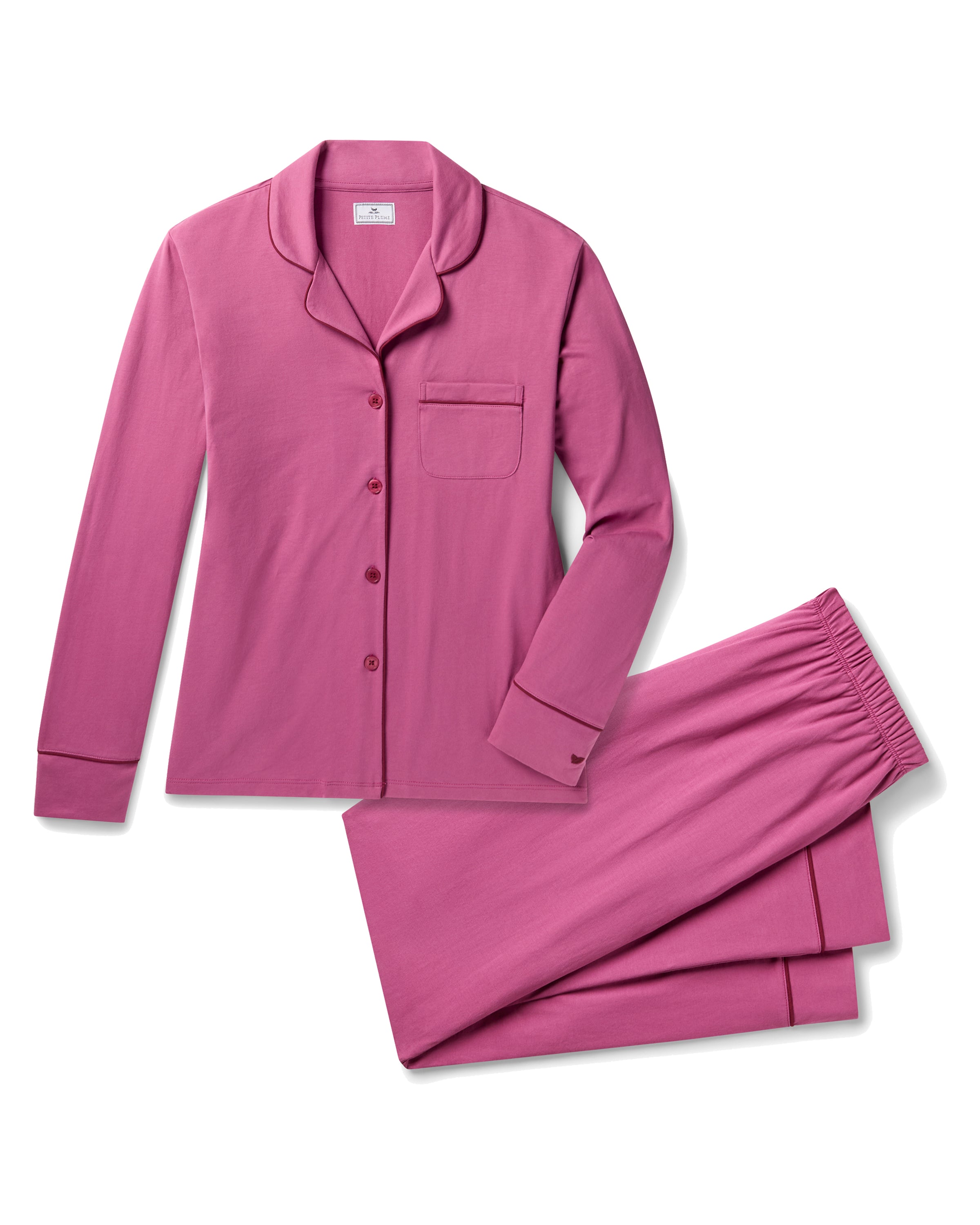 The Women's Pima Pajama Set in Rosewood, featuring a long-sleeve button-up top with a collar and chest pocket, and elastic-waist pants, is shown laid flat on a white background.