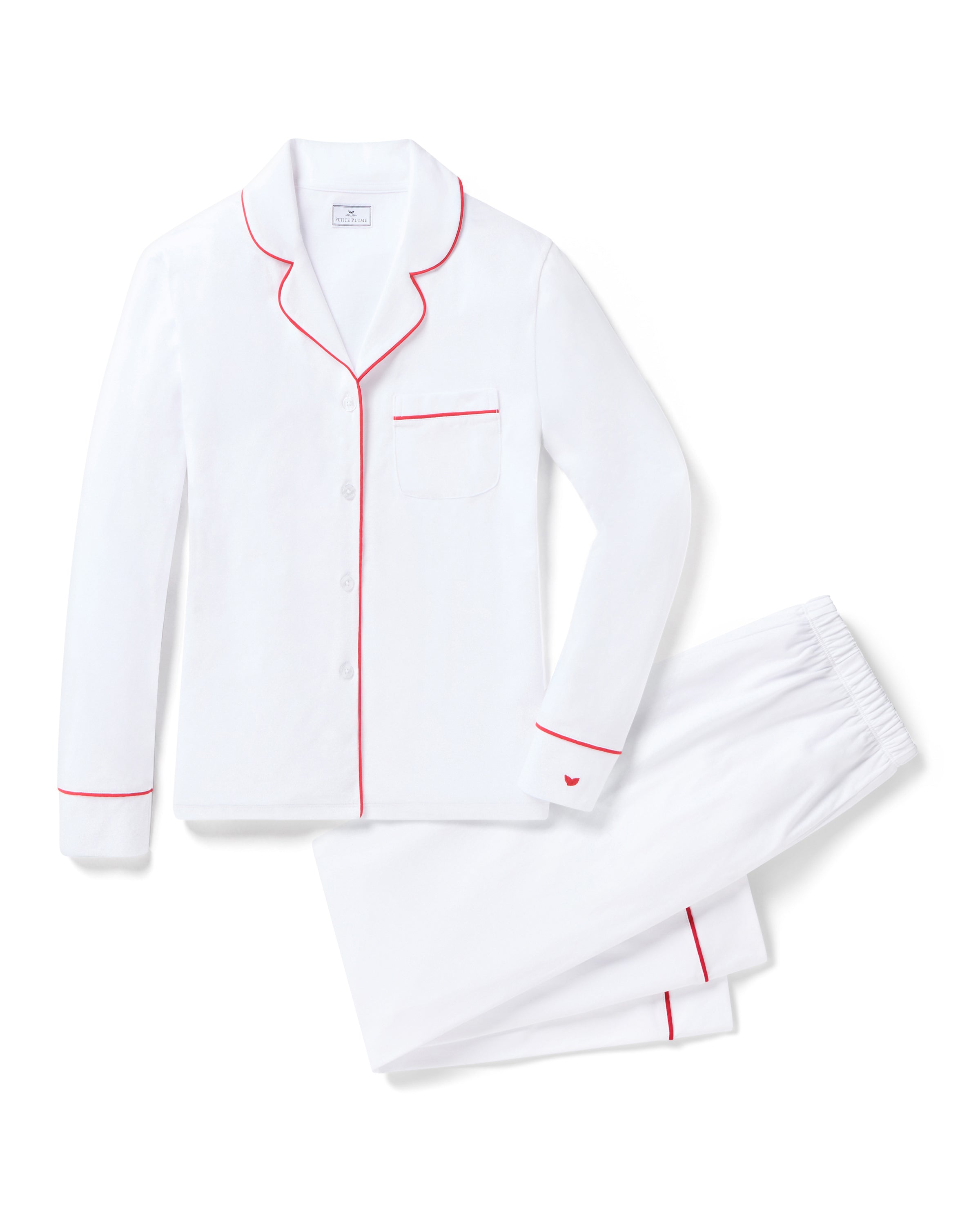 Indulge in luxury sleepwear with Petite Plumes Womens White Pima Pajama Set. Crafted from exquisite Peruvian Pima cotton, it features elegant red piping on the long-sleeve tops collar, pocket, and cuffs, paired with matching pants that offer ultimate comfort thanks to an elastic waistband.