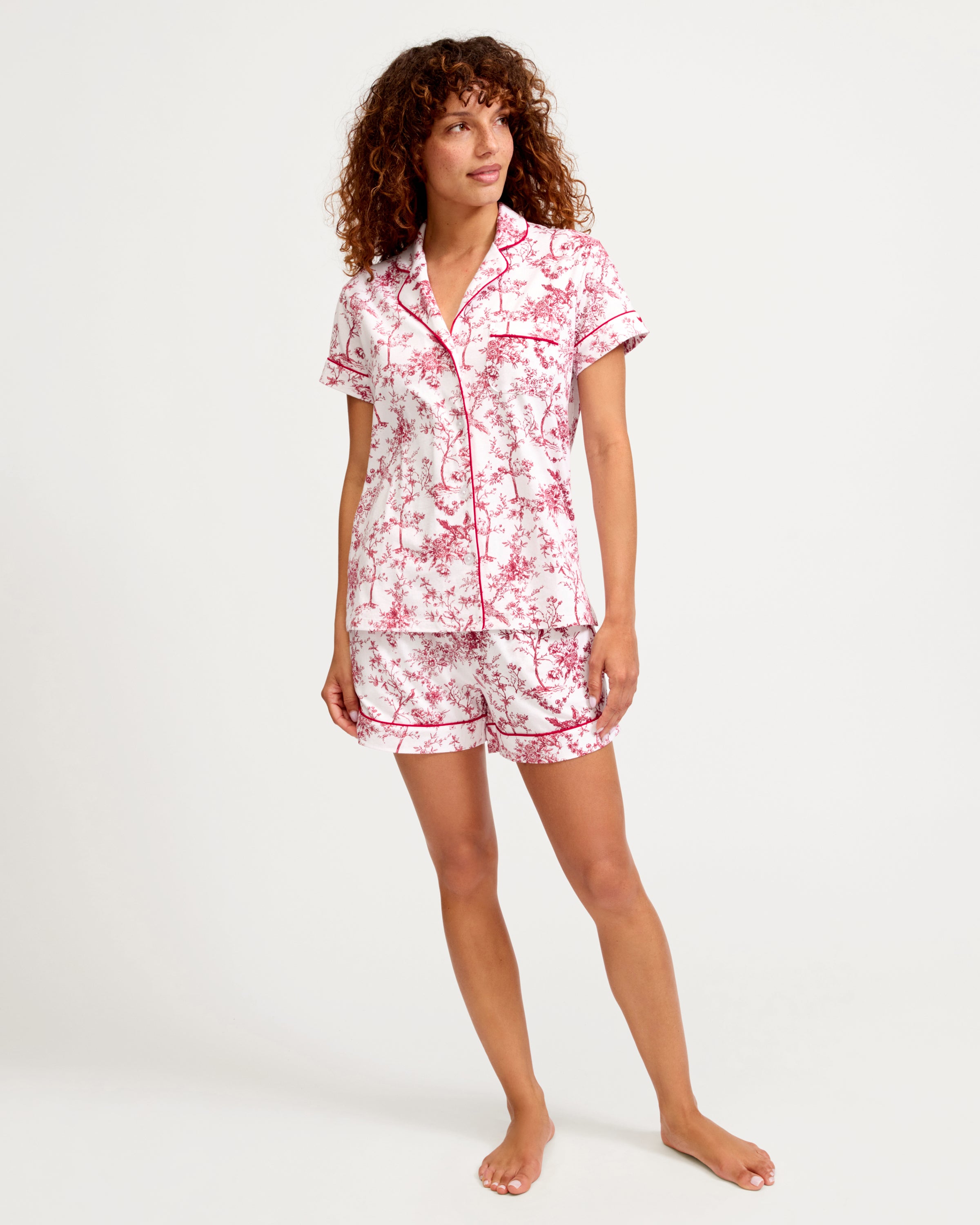Women's Pima Short Sleeve Short Set in Red Timeless Toile: a short-sleeve pajama set with a collared button-up top and shorts, adorned with a red floral print on white fabric and finished with red piping.