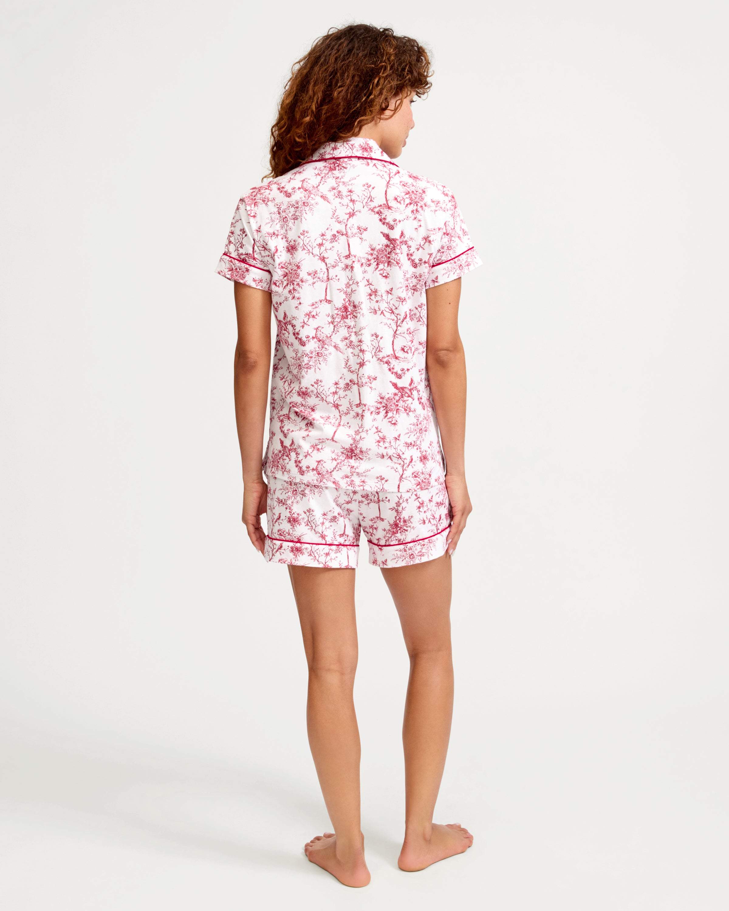 Women's Pima Short Sleeve Short Set in Red Timeless Toile: a short-sleeve pajama set with a collared button-up top and shorts, adorned with a red floral print on white fabric and finished with red piping.