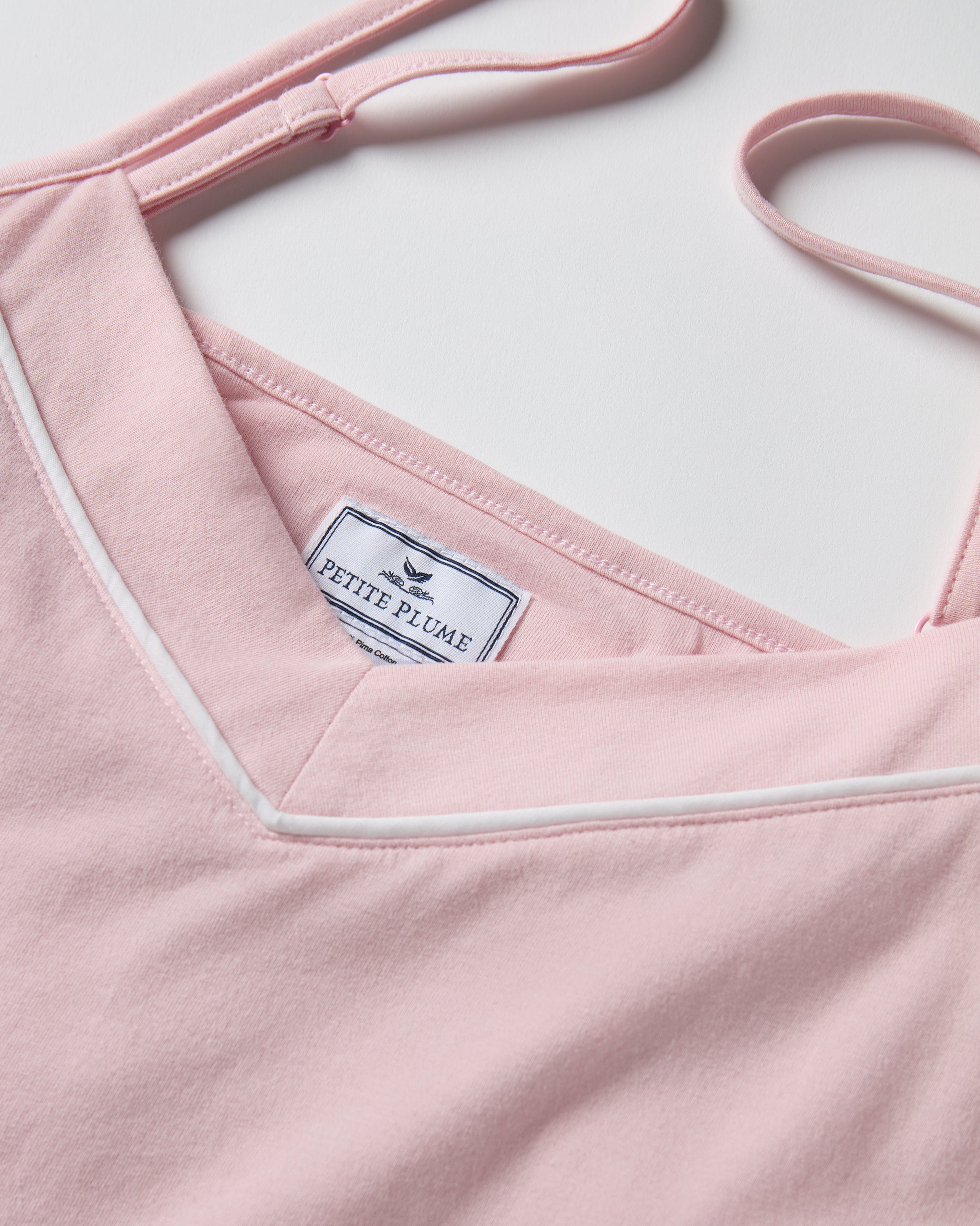 The Women's Pima Sylvie Pajama Set in Pink includes a sleeveless V-neck camisole with thin straps and matching elastic-waist pants, both accented with subtle white stitching.