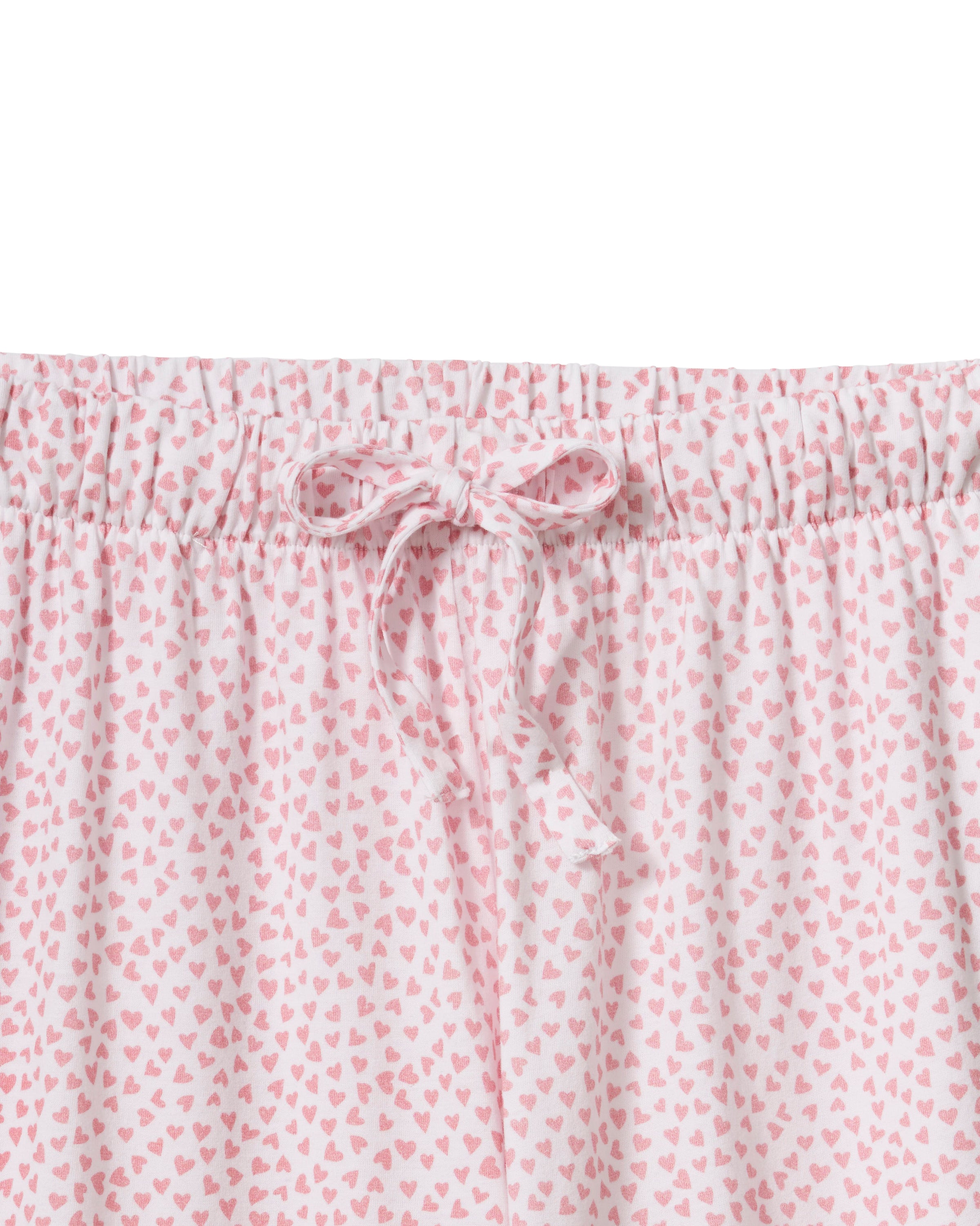 The Olivia Wide Leg Pima Pajama Set in Sweethearts features a light pink and white dotted design, with a collared long-sleeve button-up top and matching wide-leg drawstring pants.