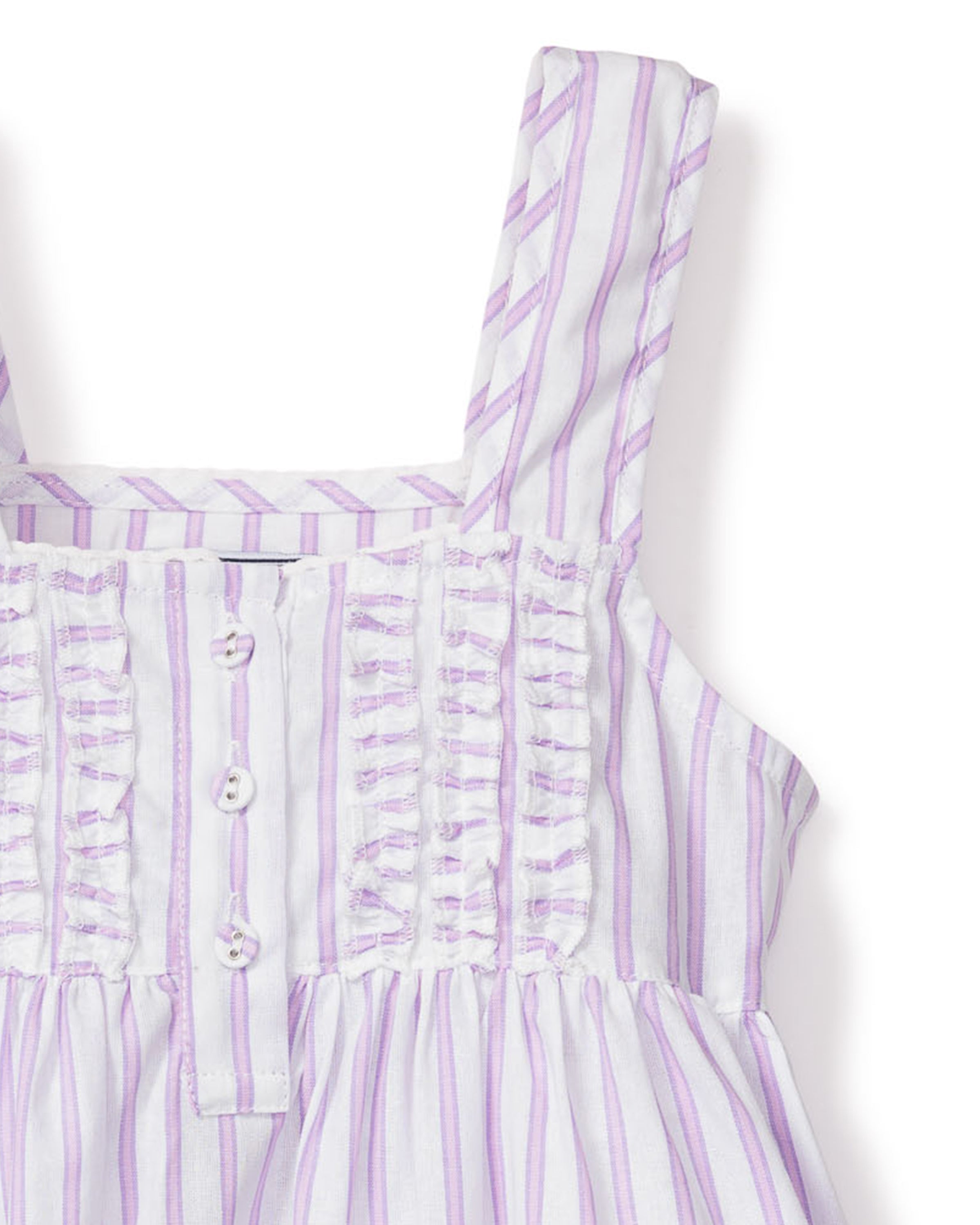 Close-up of Petite Plumes Girls Twill Charlotte Nightgown in Lavender French Ticking, crafted from yarn-dyed cotton with vertical lavender and white stripes. It features a ruched bodice with decorative buttons and soft-textured shoulder straps for a refined look.