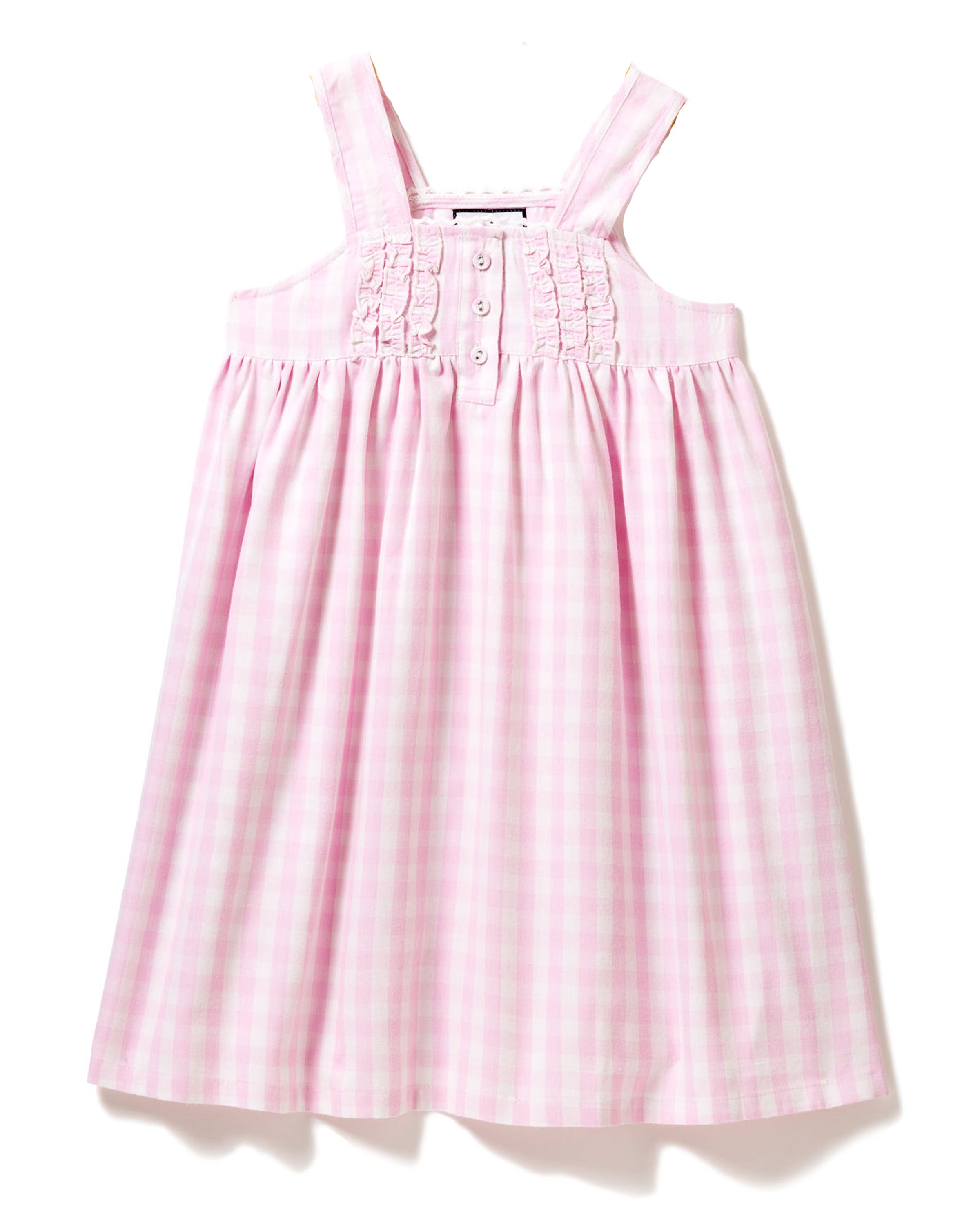 The Girls Twill Charlotte Nightgown by Petite Plume showcases a pink gingham pattern with classic wide straps, ruffled trim, and chest buttons. Made from a soft cotton blend, it offers a loose, flowing design and appears against a white backdrop.