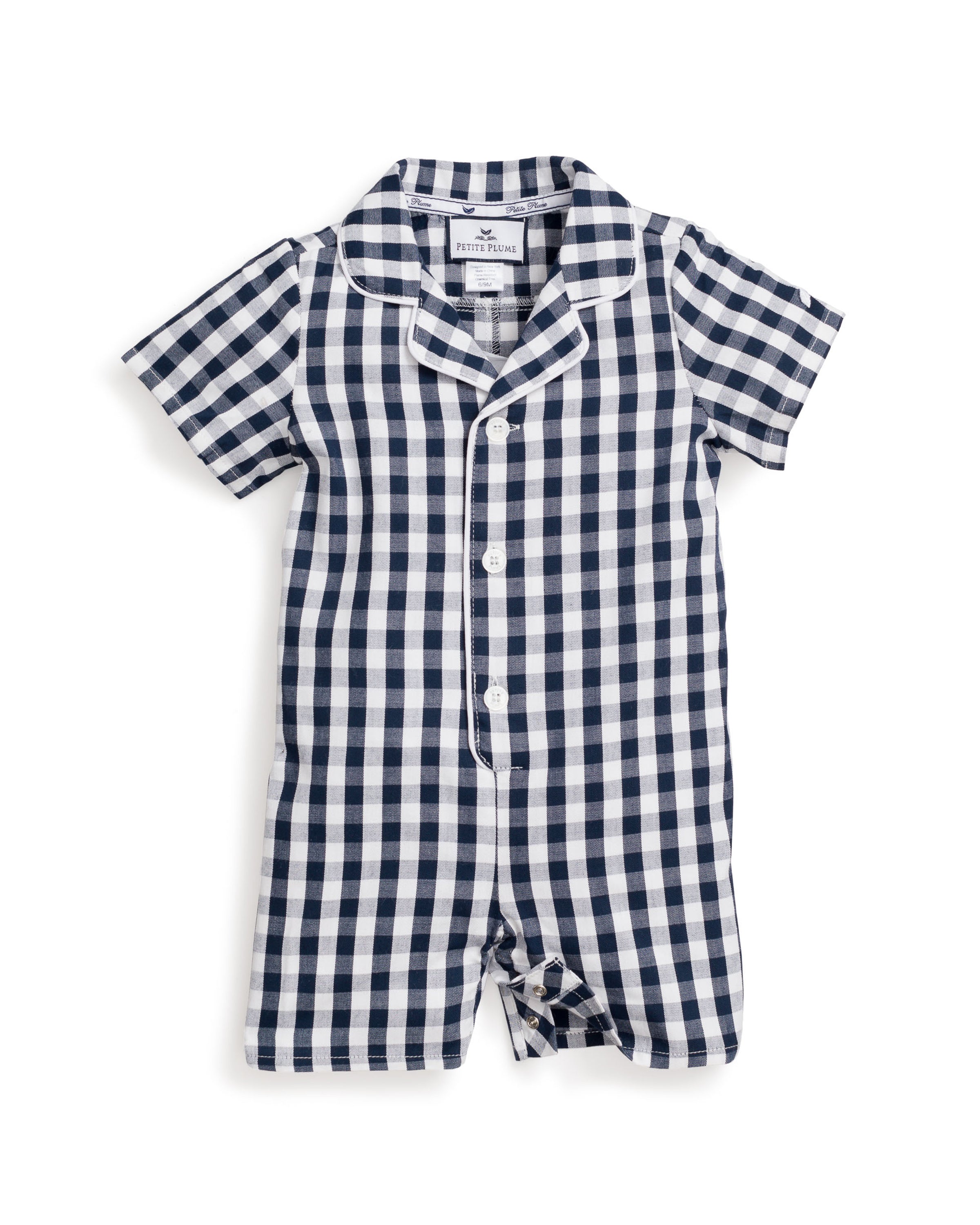 The Petit Plume Babys Twill Summer Romper in Navy Gingham is a short-sleeved, one-piece outfit with a navy and white checkered pattern, button-down front, white piping, and a small collar for an elegant look.