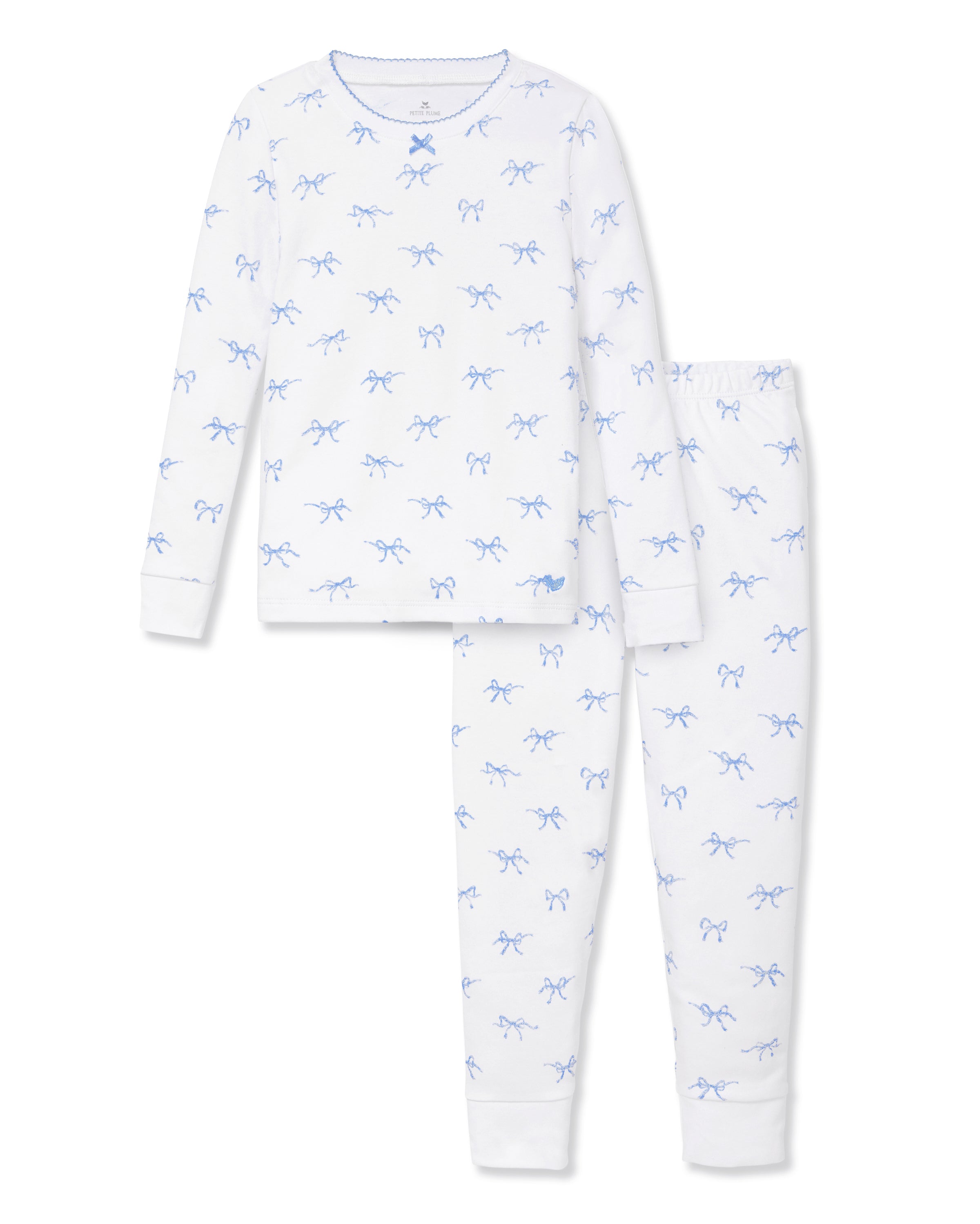 The Kid's Pima Snug Fit Pajama Set in Something Blue Bows features a long-sleeve white top and matching pants with a light blue bow pattern, crew neckline, and soft, comfortable fabric.