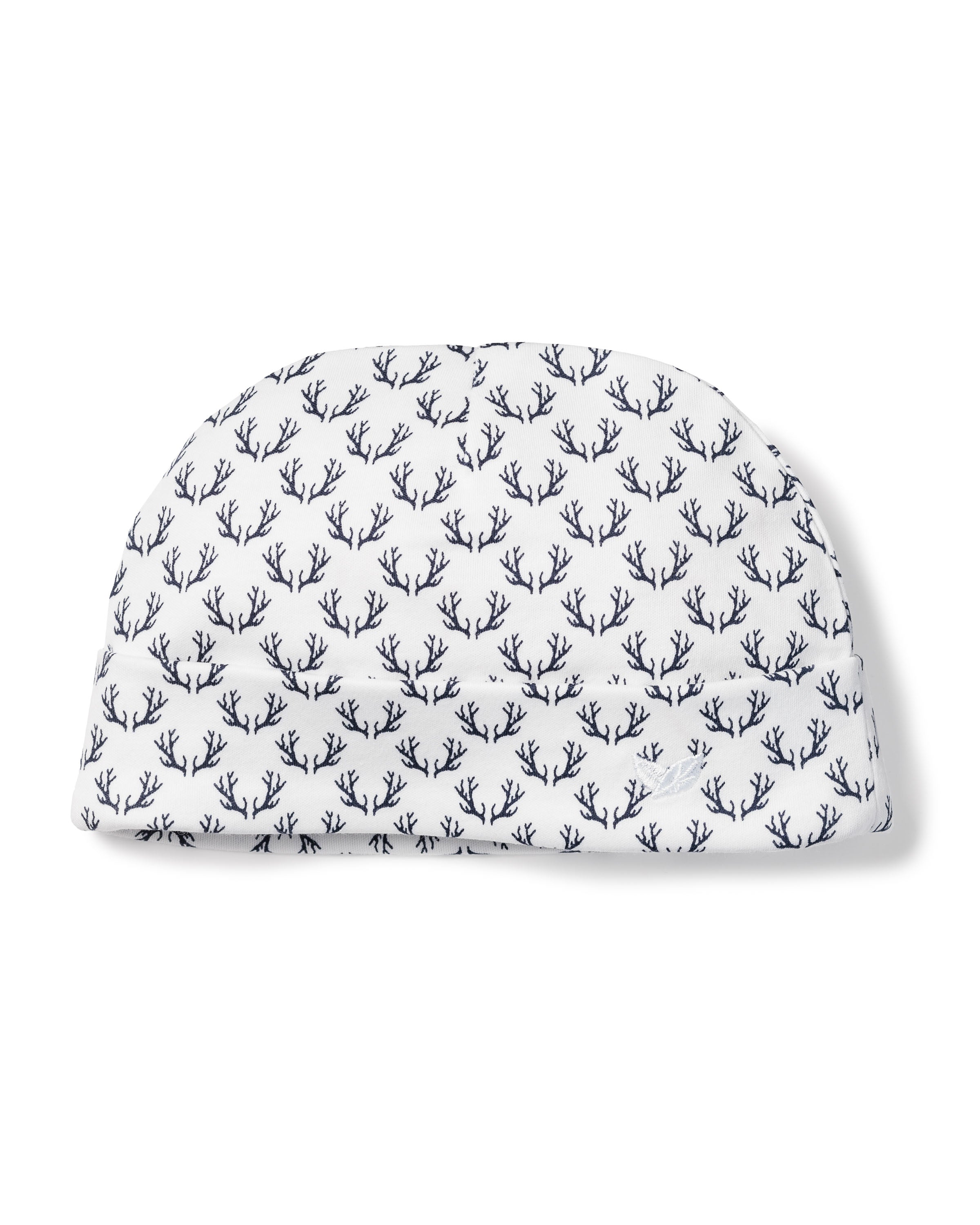 The Babys Pima Hat in Nordic Antlers by Petite Plume is a white domed hat crafted from Peruvian Pima cotton, featuring a navy blue abstract branch pattern—perfect for a babys delicate skin.