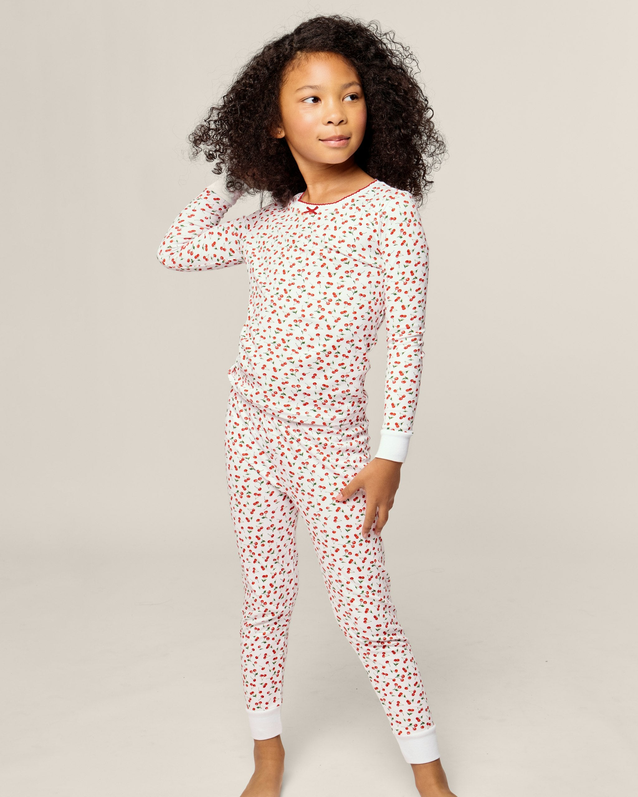 Children's pajama set with red heart pattern on a white background