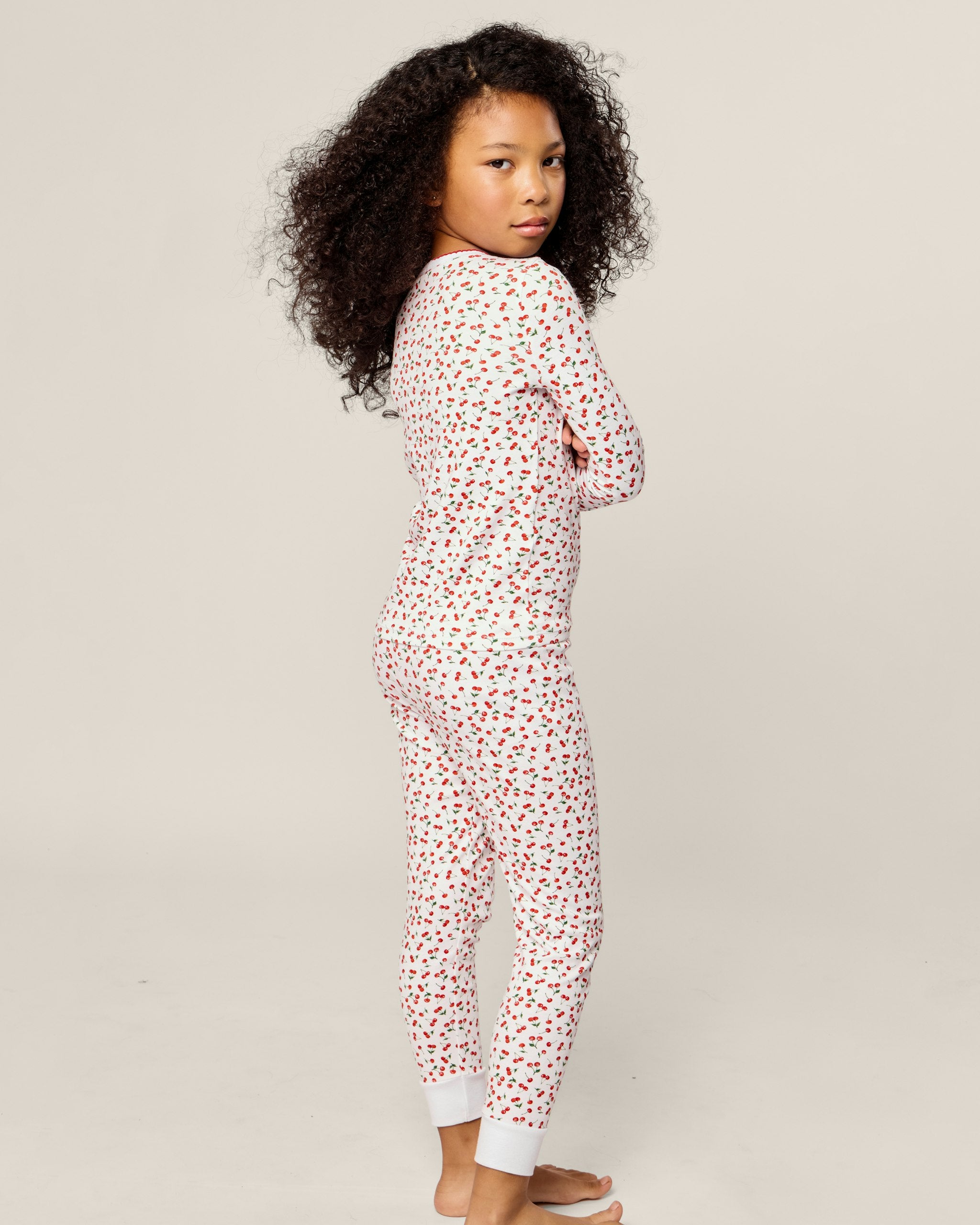 Children's pajama set with red heart pattern on a white background