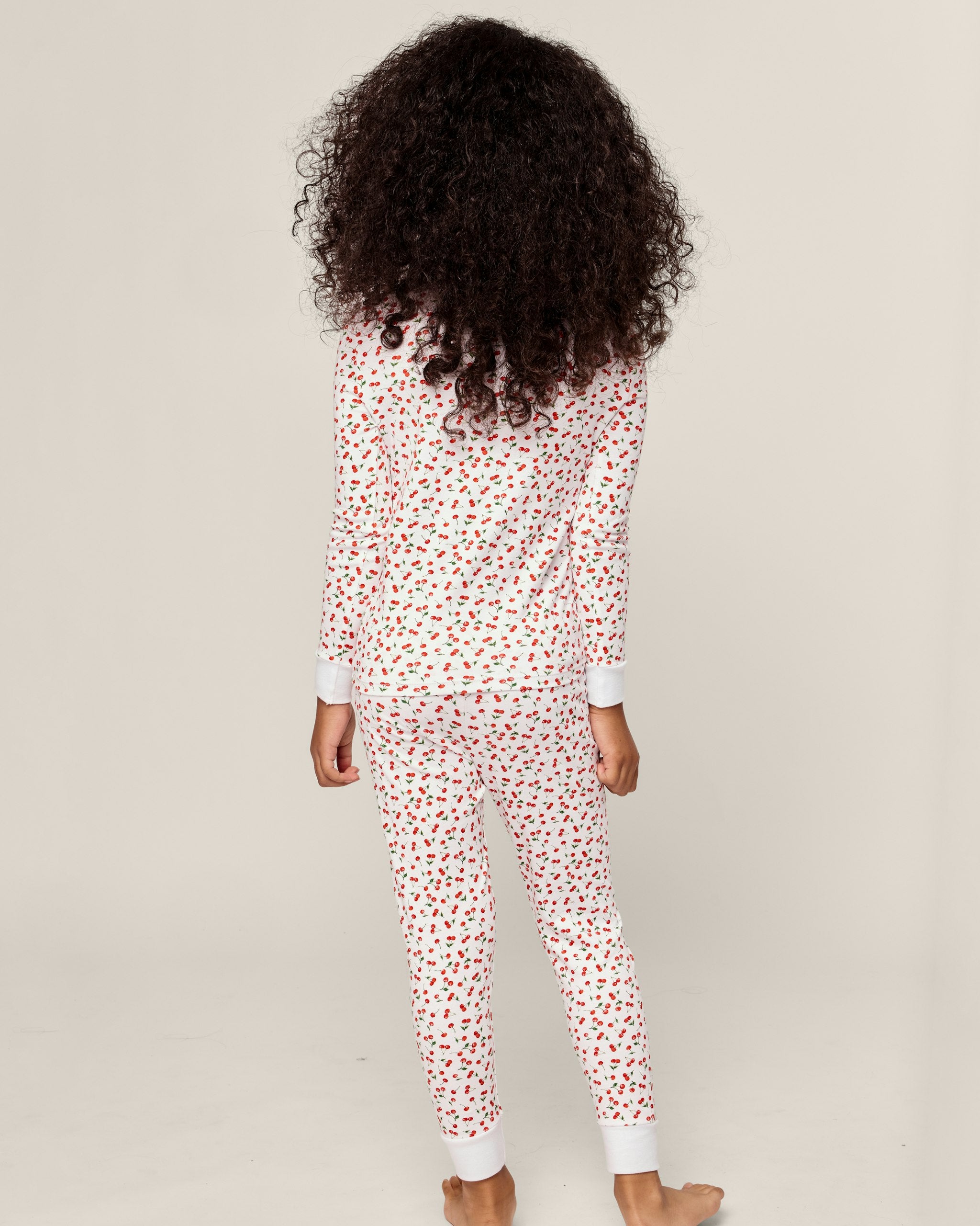 Children's pajama set with red heart pattern on a white background
