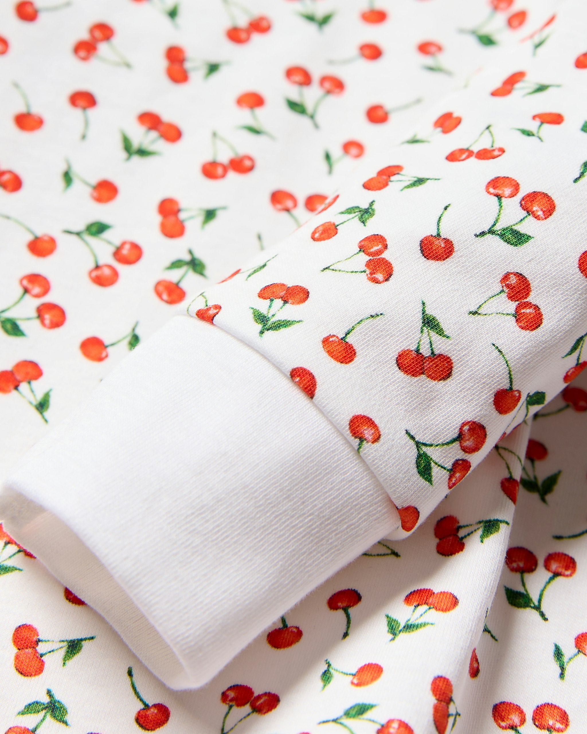 Children's pajama set with red heart pattern on a white background