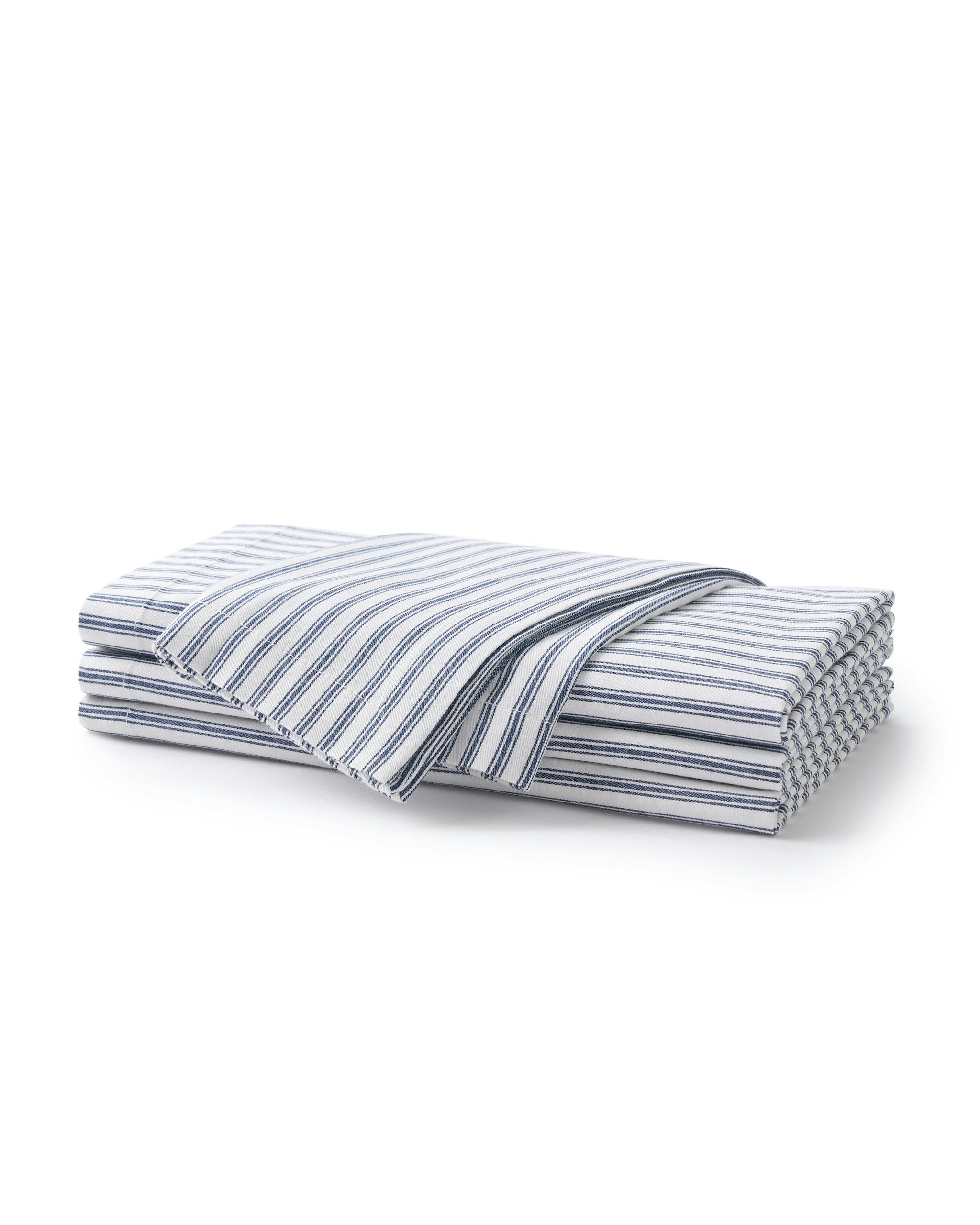 Folded blue and white striped fabric on a white background