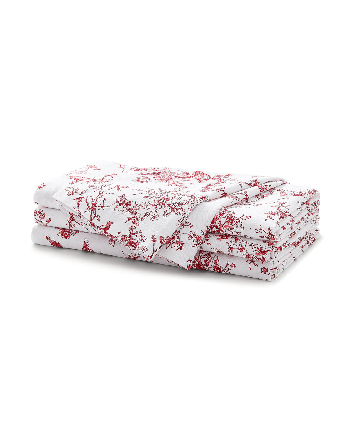 A set of Signature Twill Napkins in Red Timeless Toile, neatly folded with a red floral and branch pattern, displayed on a plain white background.