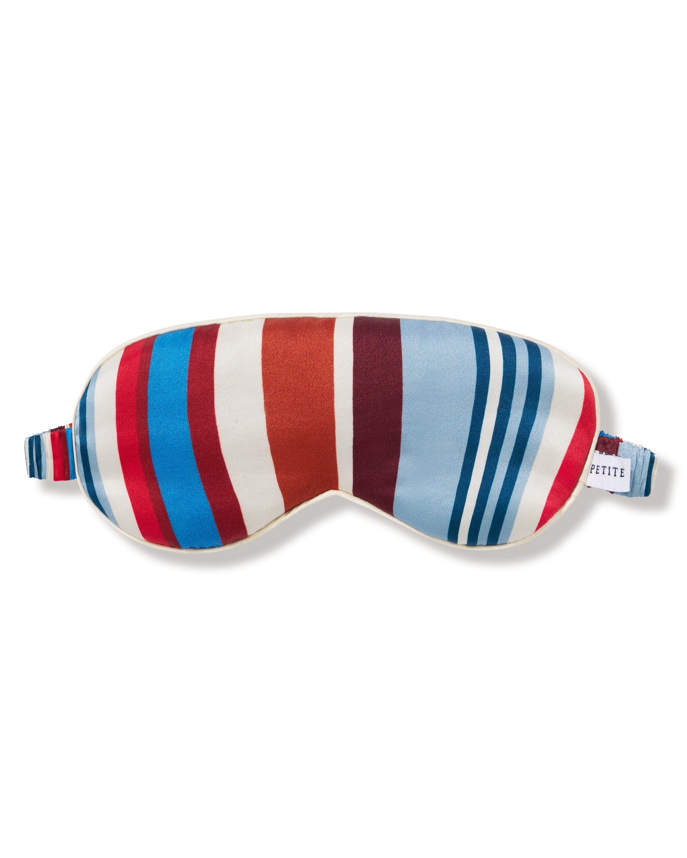The Silk Eye Mask in Discovery Stripe features bold vertical blue, red, and white stripes, an elastic strap, and a small white label on the right side.
