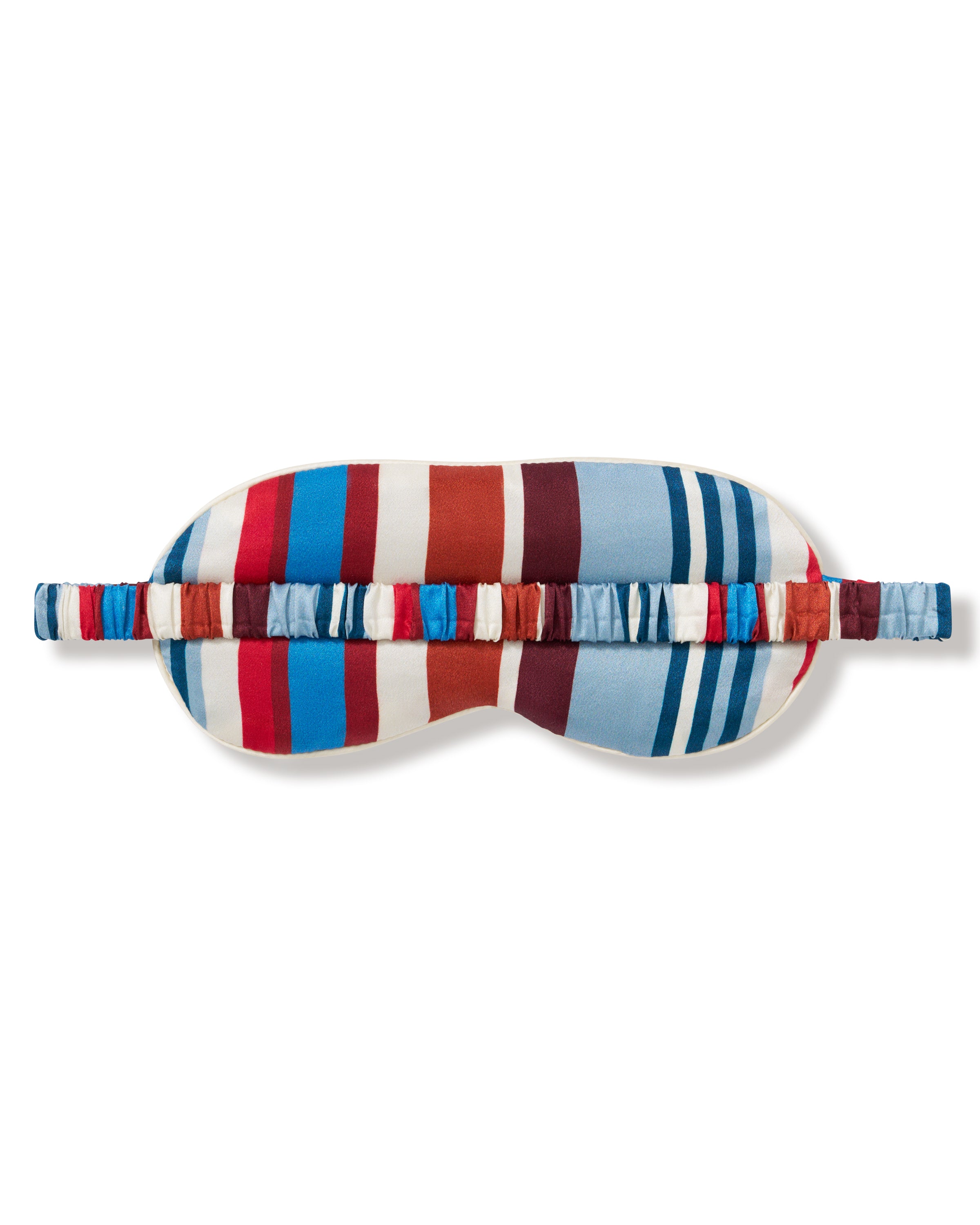 The Silk Eye Mask in Discovery Stripe features bold vertical blue, red, and white stripes, an elastic strap, and a small white label on the right side.