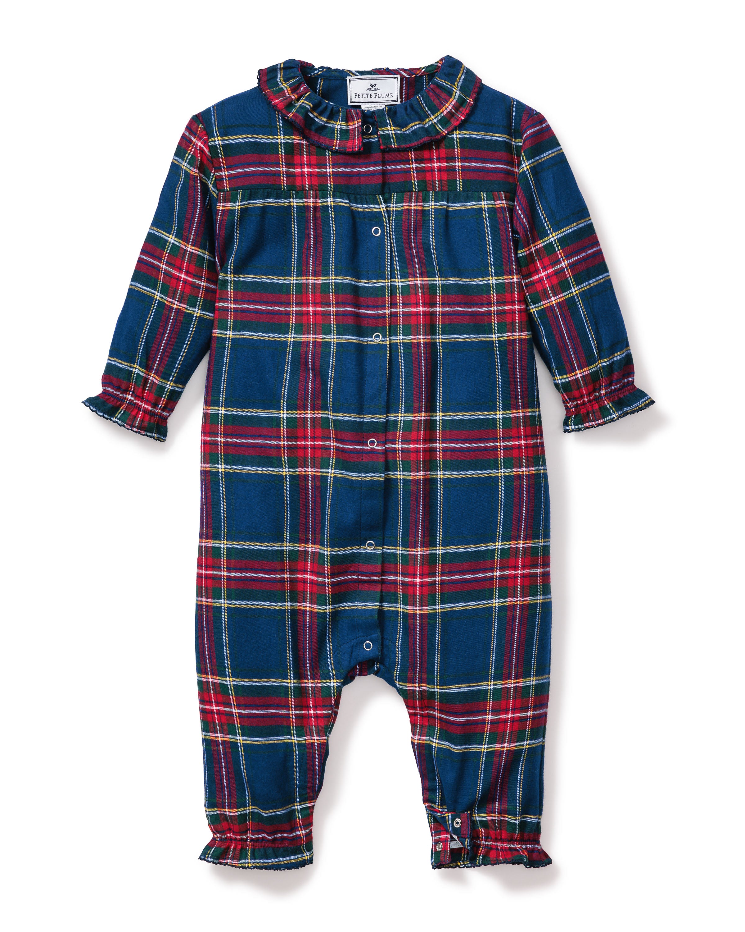 Close-up of the Babys Brushed Cotton Madeline Romper in Windsor Tartan by Petite Plume, featuring a plaid design with red, green, and blue colors, a ruffled collar, and snap buttons. The label ensures it is chemical-free for comfort and peace of mind.