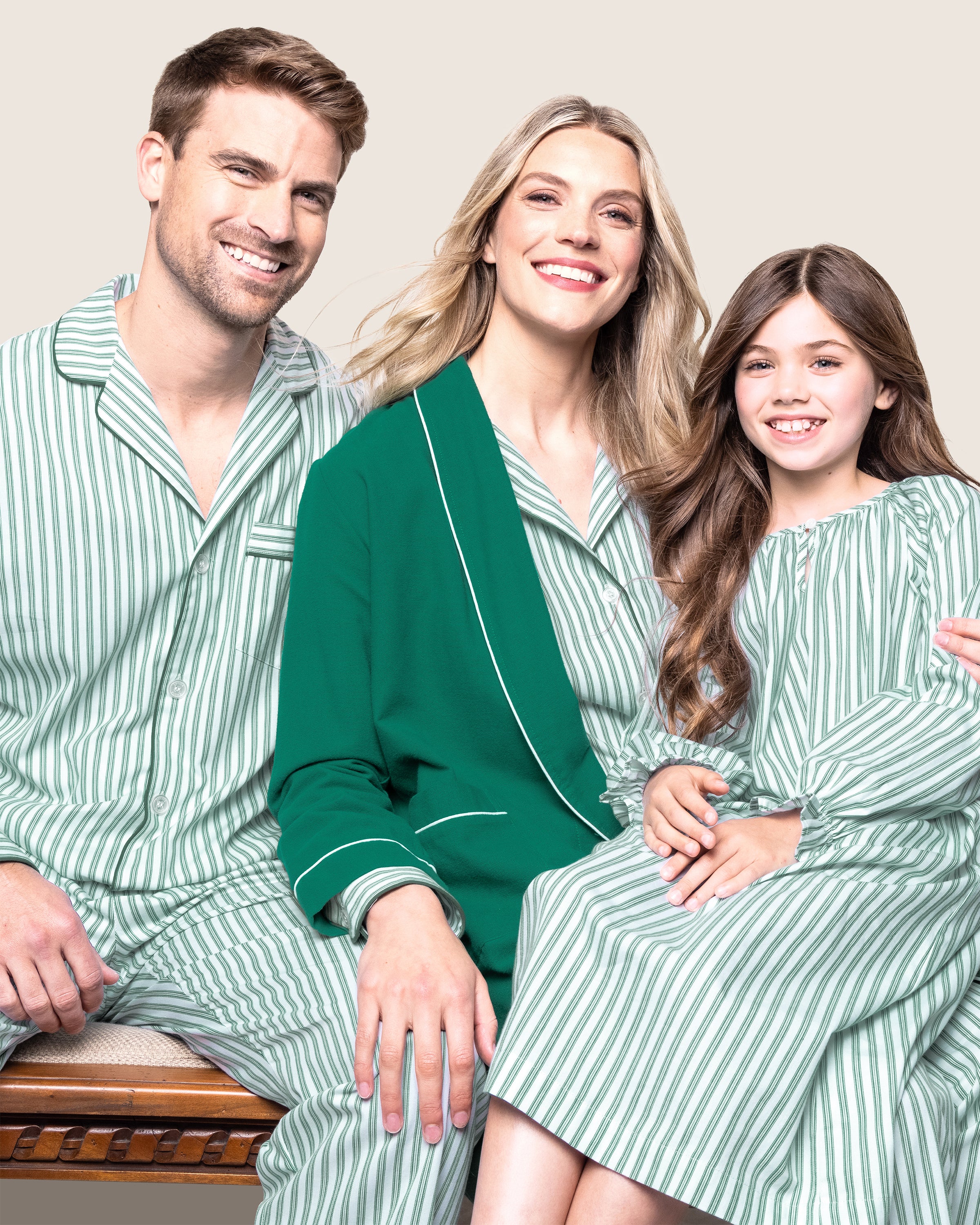 The Girl's Twill Delphine Nightgown in Emerald Ticking features vertical green and white stripes, long sleeves with ruffled cuffs, a gathered neckline, and a small bow detail at the center.