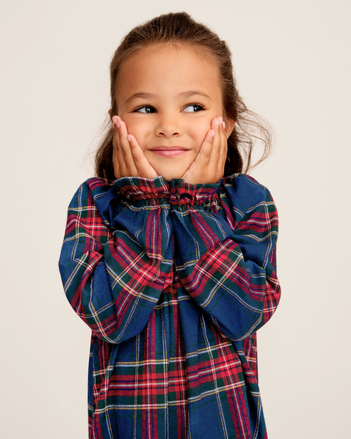 The Girl's Brushed Twill Delphine Nightgown in Windsor Tartan features a blue, green, and red plaid pattern, knee-length long sleeves with ruffled cuffs, and a round neckline with a small button.