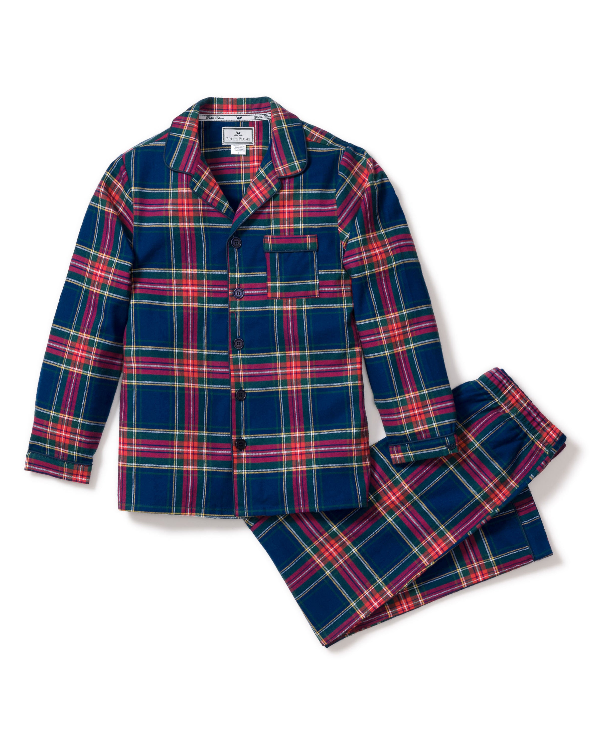 Close-up of a lavish Kids Brushed Cotton Pajama Set in Windsor Tartan by Petite Plume, showcasing red, blue, green, and yellow intersecting stripes forming squares and rectangles. A visible button and seam complete this classic pajama look.