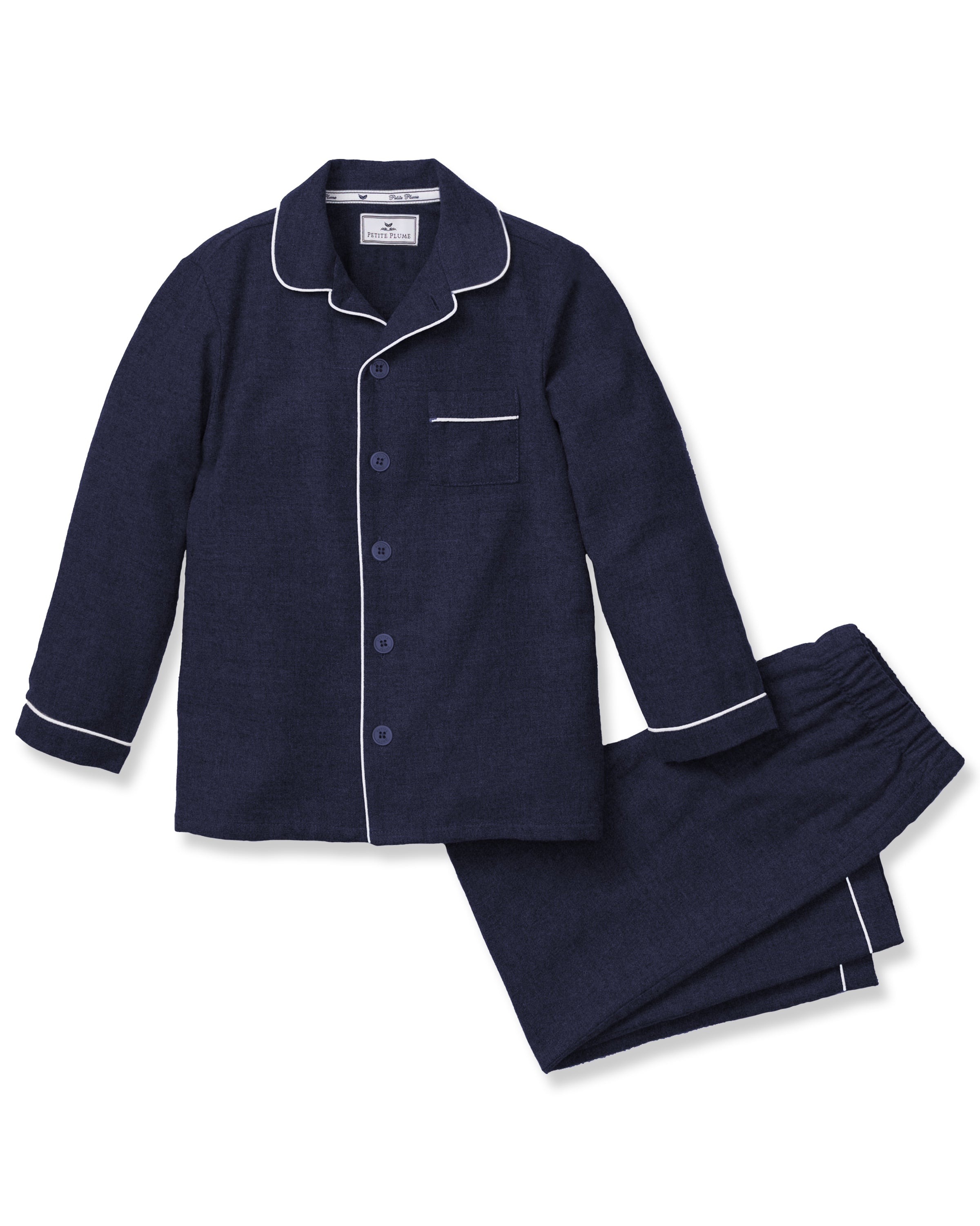 Petite Plumes Kids Flannel Pajama Set in Navy is a chemical-free sleepwear option with a soft appearance, featuring contrasting white piping. It includes a long-sleeve button-up top with a chest pocket and matching elastic-waistband pants.